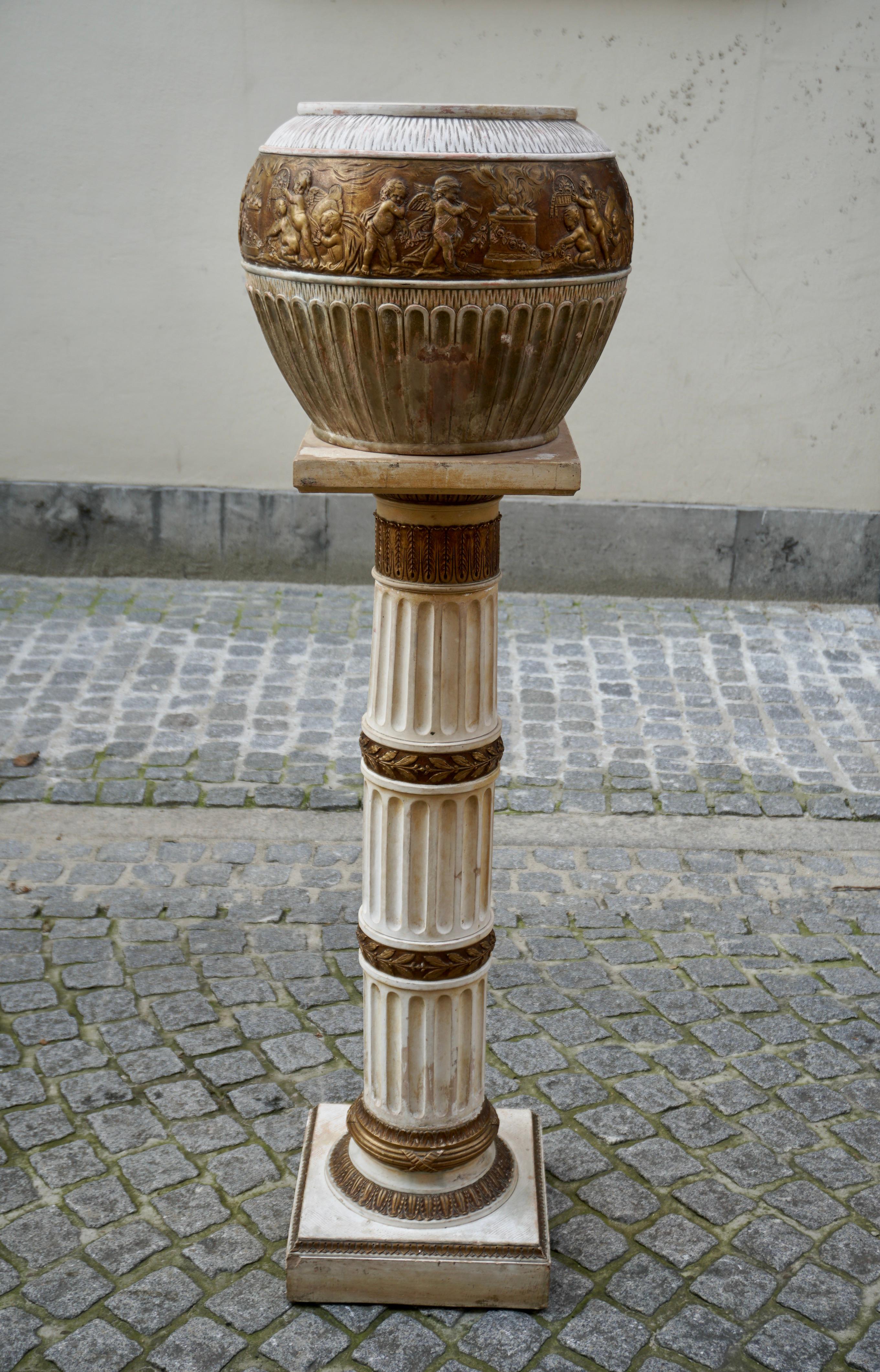 Ornate gilt pedestal terracotta planter pot stand decorated with putti cherub made in Napoli, Italy.

Condition Report column and jardiniere
In good, structurally sound and sturdy condition with some spotting mostly near the bases as shown. The