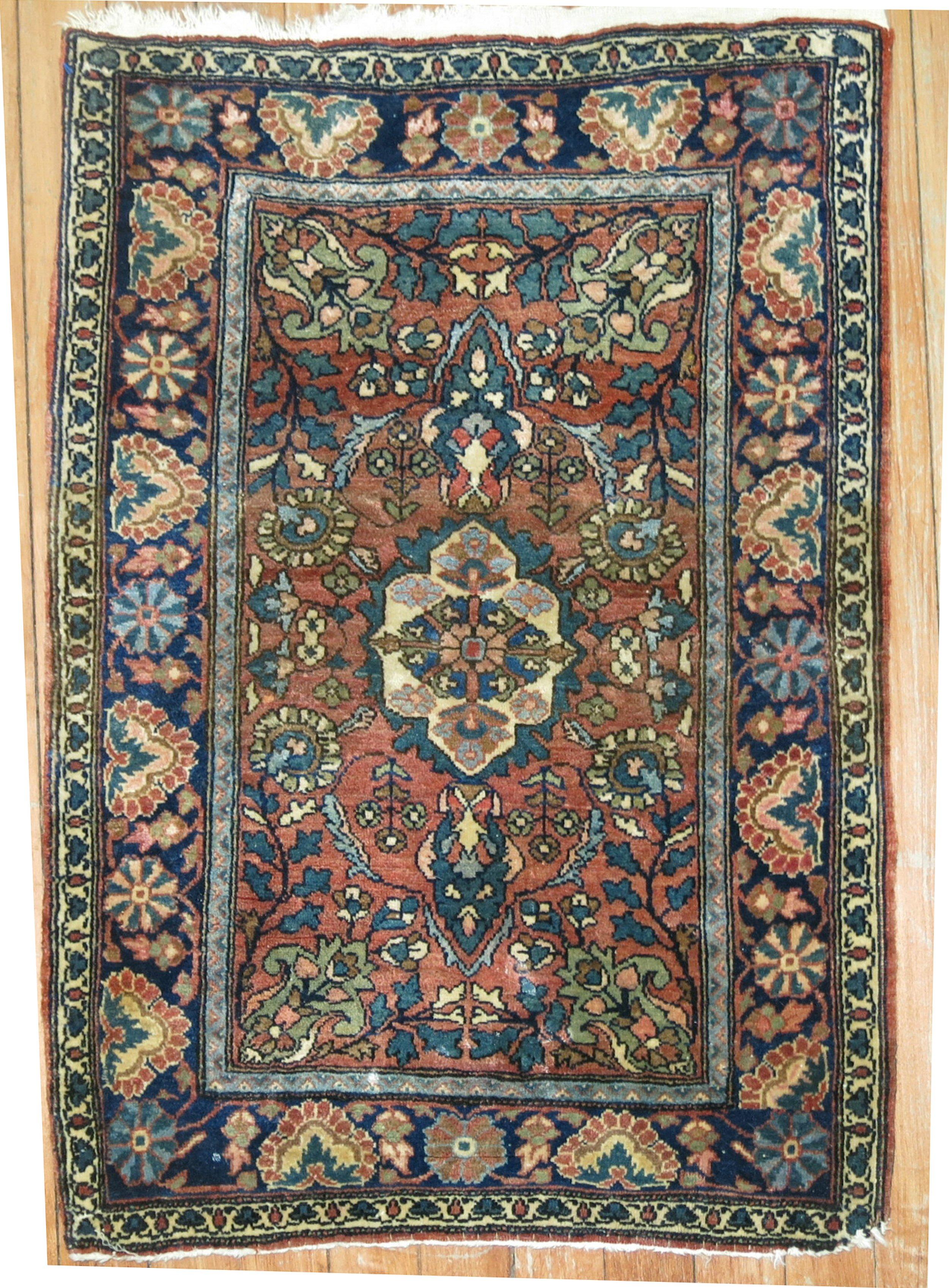 An early 20th-century high collectible Persian Sarouk Farahan rug with an ornate palette in earth tones

Measures: 1'9'' x 2'6”.

