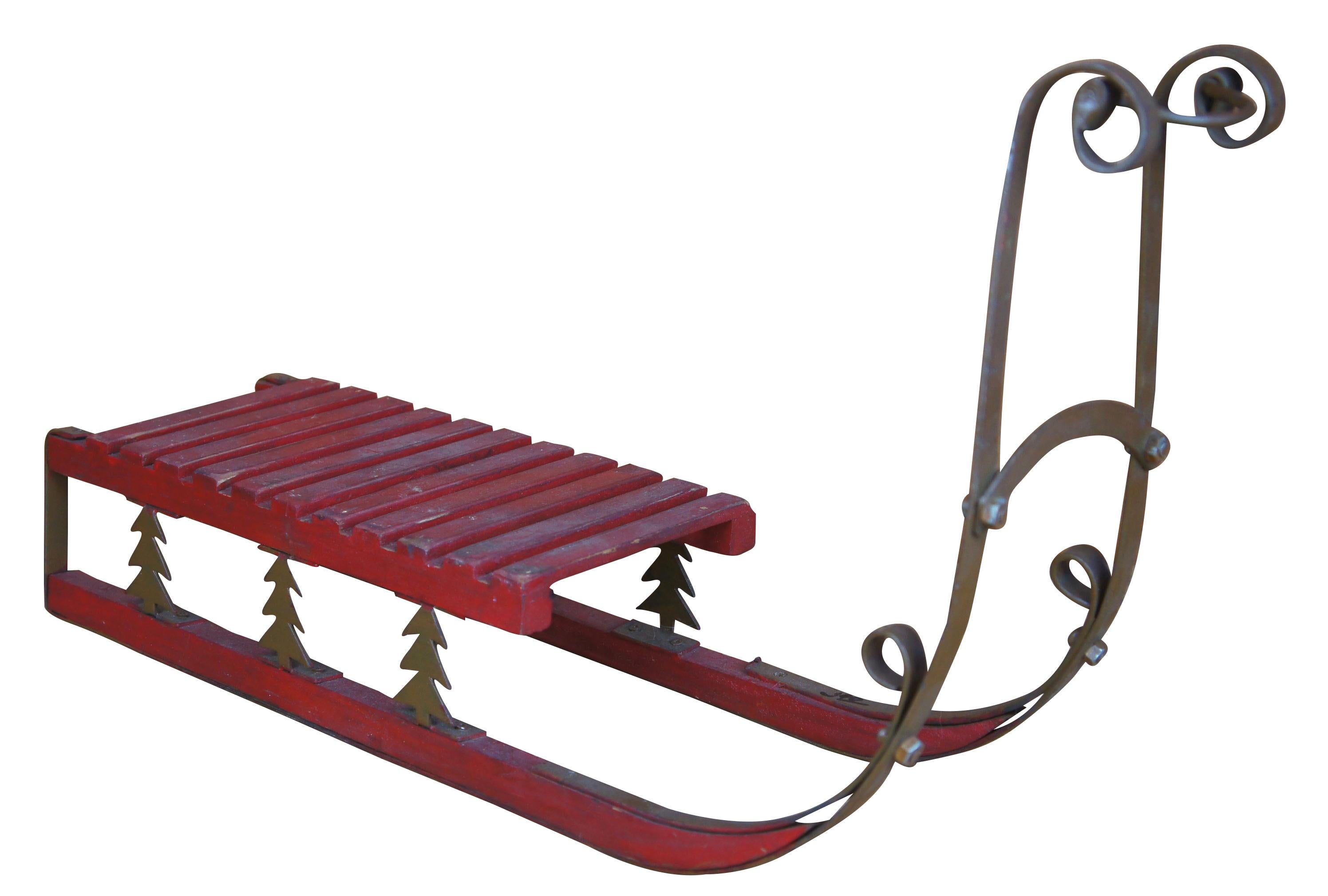 Vintage folk art toy or child's Christmas sleigh/ sled / toboggan. Made of slatted wood with scrolled iron accents featuring cut out Christmas trees. Measures: 23