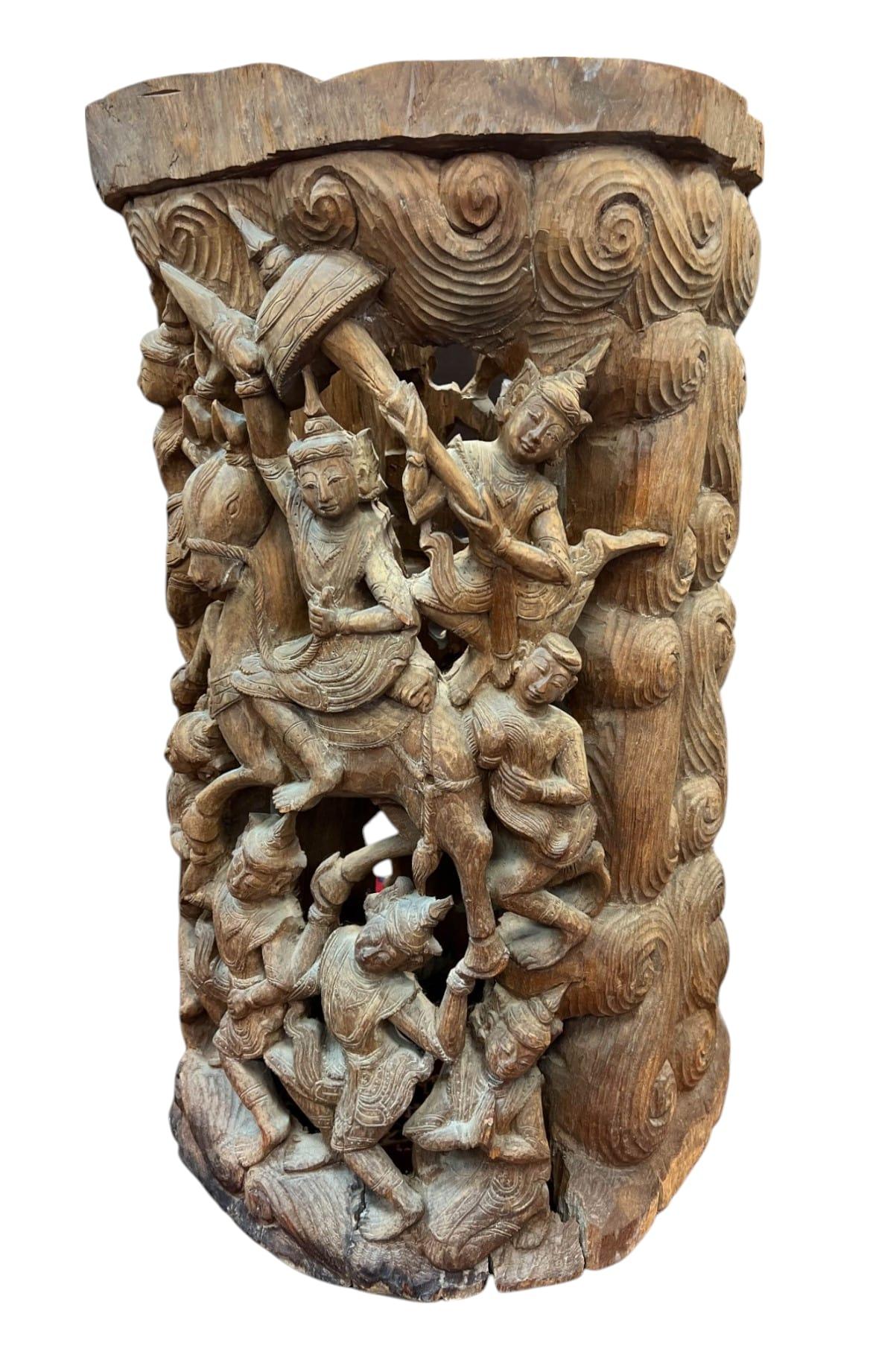 This substantial carved wood fragment originates from a traditional Thai temple or royal structure, likely once part of a column, pillar, or large decorative panel. Crafted from teak, it features intricate high-relief carvings depicting celestial