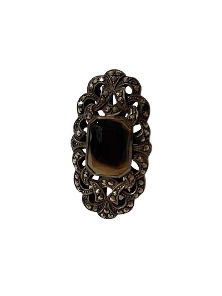 This is a large and ornate sterling silver and marcasite ring. It's sure to make an impression on its beholders. The center stone is fantastic and mysterious. It's boho-chic and classic!

The dimensions of this ring are:
1.5