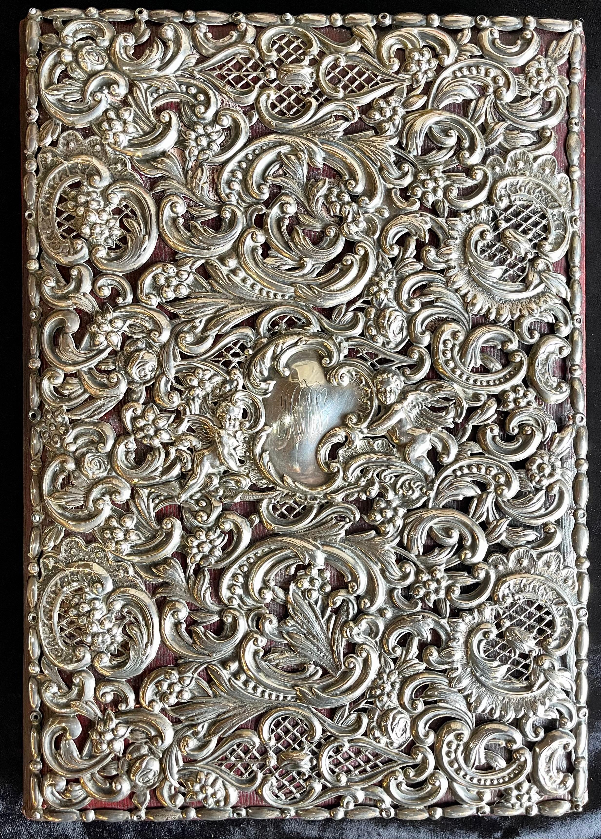 Ornate sterling silver book cover photo scrap album w red leather interior. Large and impressive. 
Marked Sterling 48


Meryl.