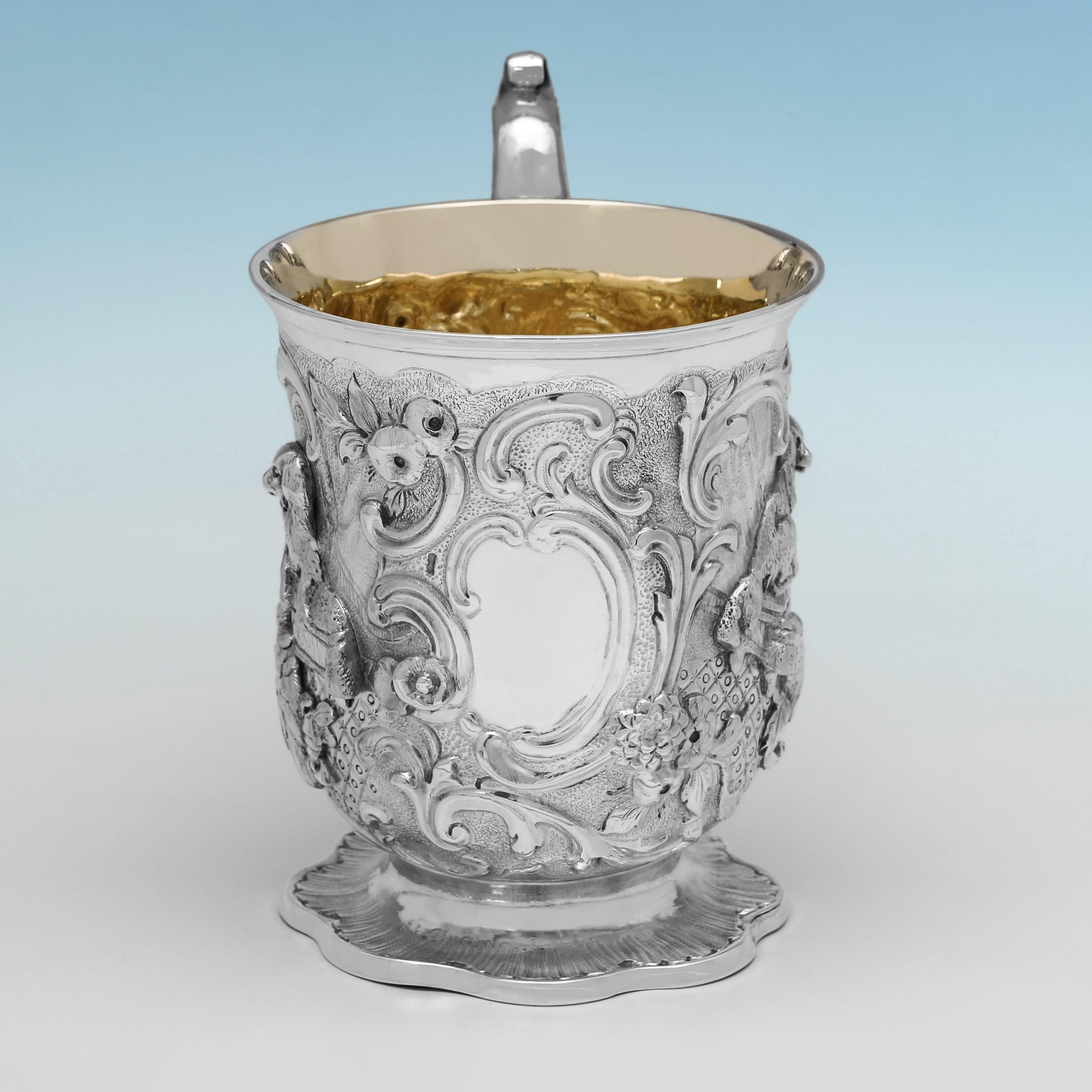 Delightfully ornate and steeped in Victorian charm, this sterling silver child’s mug was hallmarked in London in 1847 by renowned silversmith J.C. Edington. A superb example of 19th-century English silver, the mug features highly detailed repoussé