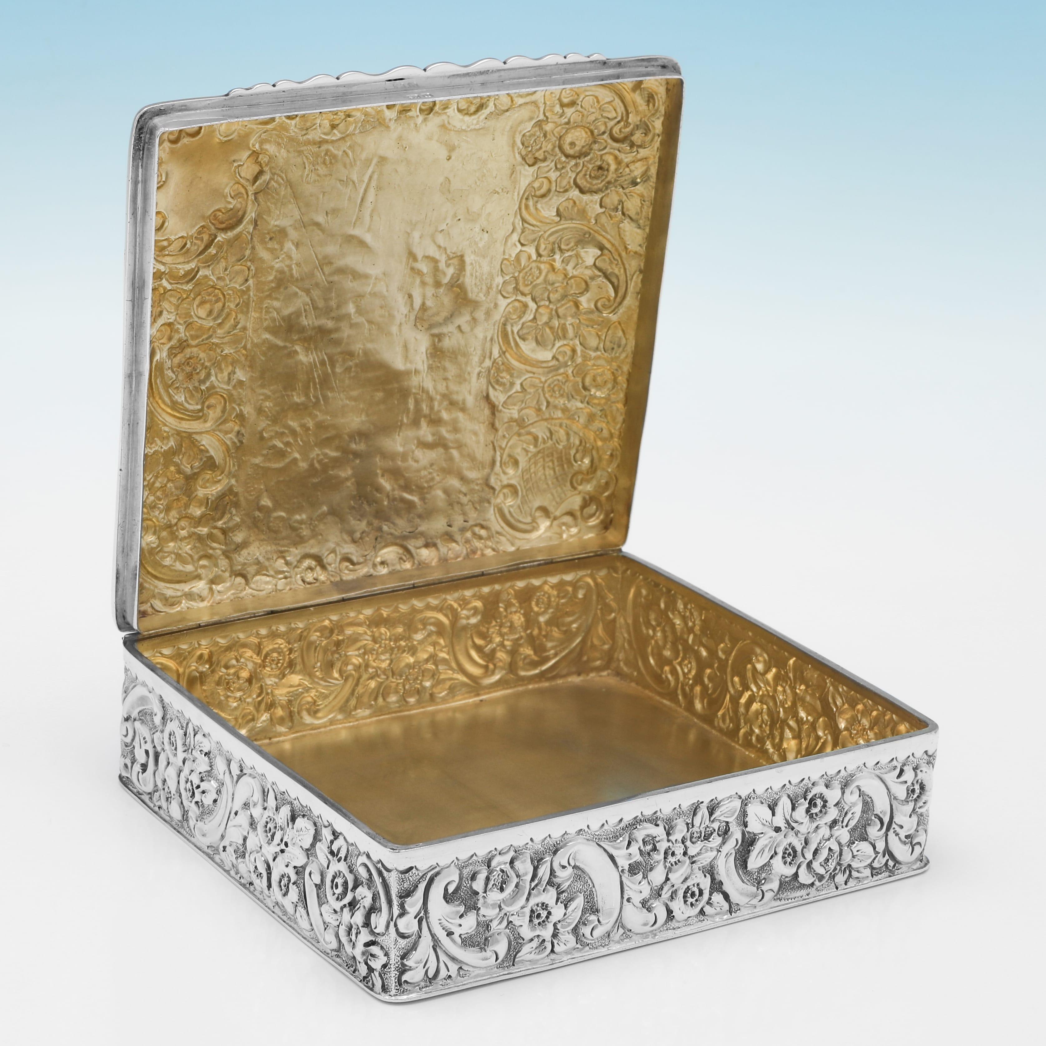 Hallmarked in Chester in 1899 by Nathan & Hayes, this very attractive, Victorian, Antique Sterling Silver Dressing Table Box, is ornately decorated throughout, with a scene on the lid of 2 putti playing on a seesaw, and a gilt interior. The box