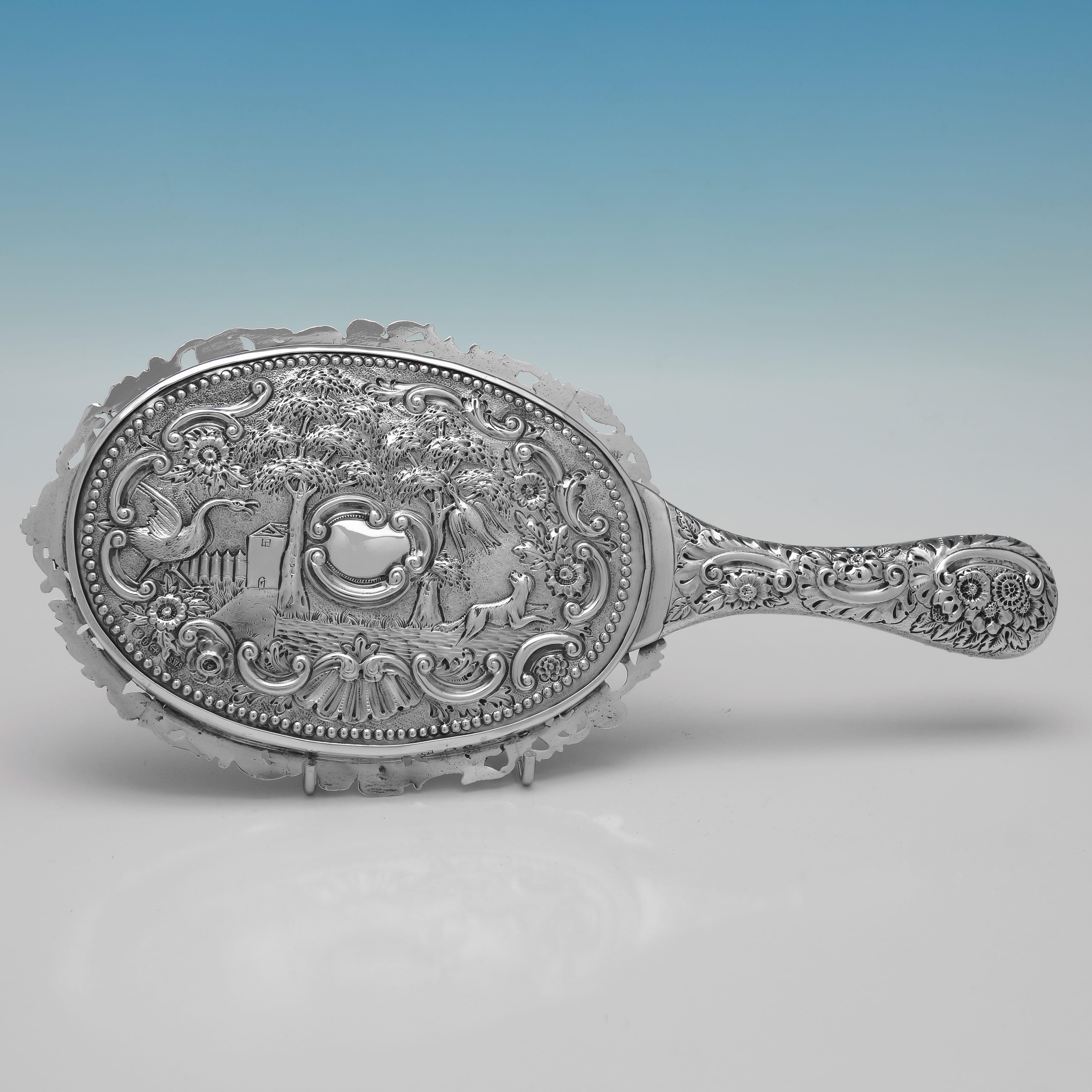 Hallmarked in Birmingham in 1890 by Samuel Walton Smith, this Antique, Sterling Silver Hand held Mirror measures 10.75