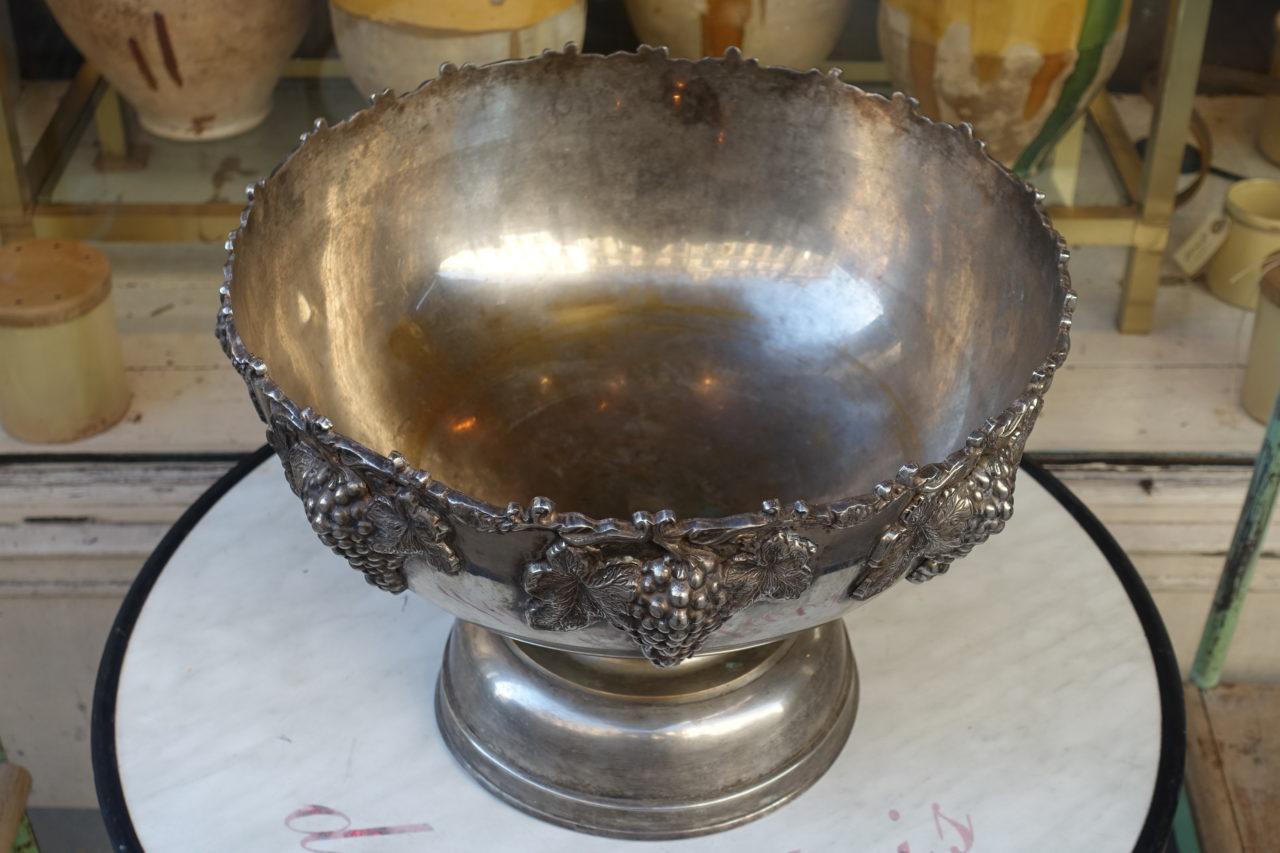 Huge and handsome vintage champagne / wine ice bucket, made of tin, with amazing patina, and gorgeous cast decorations of vines and grapes along the edge. Raised up on a wonderful base