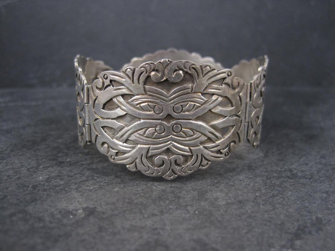 This gorgeous, ornate bracelet is sterling silver.

It measures 1 1/4 inches wide and 7 inches when clasped.
Weight: 41.9 grams

Marks: 925, A, Ruiz, M, Igualagro

Condition: Excellent