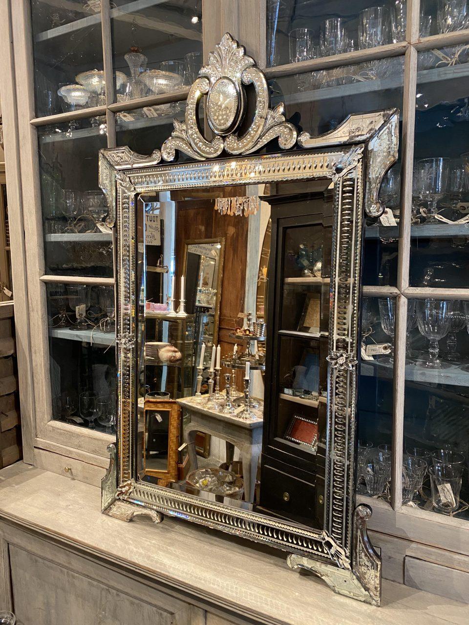 Magnificent and elegant rectangular Venetian mirror, from France circa 1920-30s. Stunning patina in all the mirror glass and the elegant pearl beading in the frame around the faceted mirror glass as well as the imposing and rare top piece that