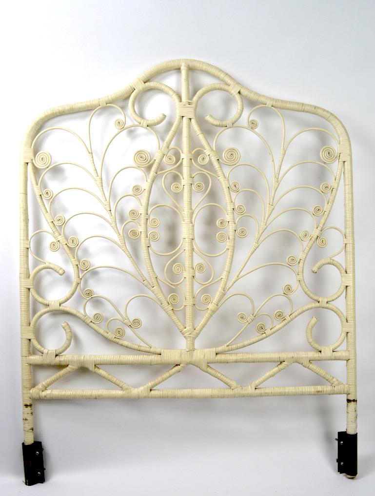 Decorative wicker headboard in original white paint finish. Standard single bed size, clean ready to use condition, circa 1970s. Interior width ( brackets ) 37.5 inches.