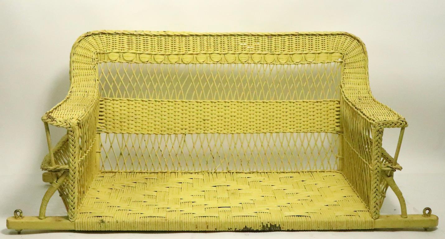 Unusual wicker porch swing designed to be suspended from the ceiling by chains (not included). The bench form swing is in very good condition, clean and ready to install.
Measures: Total H 25 x arm H 16 inches.
Ornate woven wicker, currently in