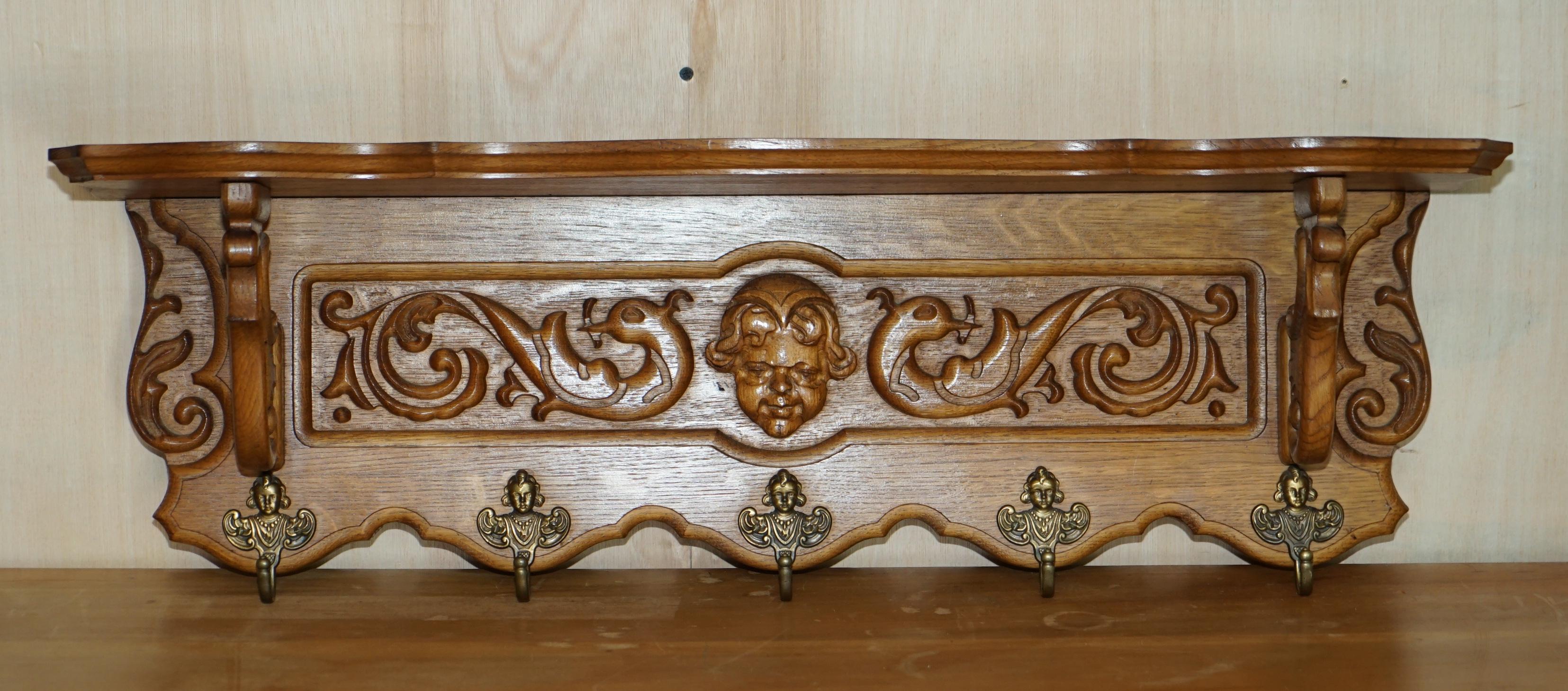 We are delighted to offer for sale this lovely, heavily carved Dutch oak wall hanging coat hat and scarf rack with French Royalty head gold gilt brass hooks and large Cherub head carved to the central middle 

A very good looking well made and