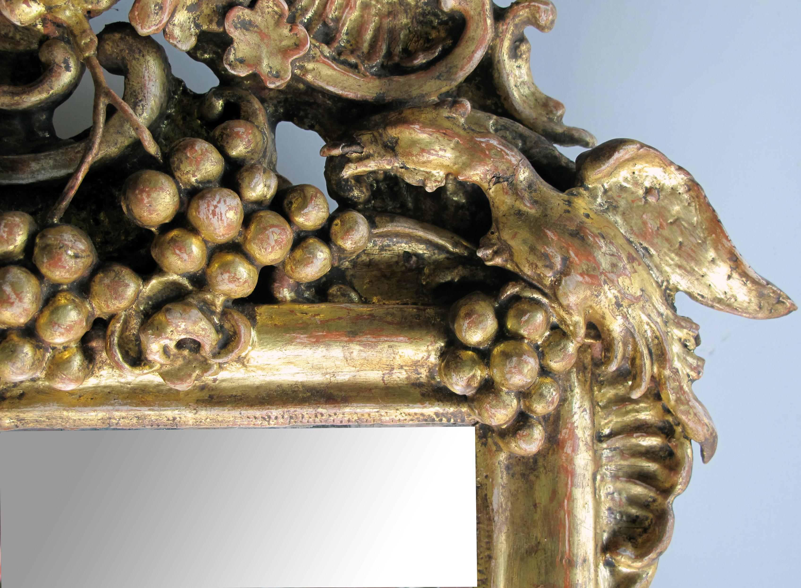 Ornately Carved French Rococo Gilt-wood Mirror with Exuberant Crest In Good Condition For Sale In San Francisco, CA