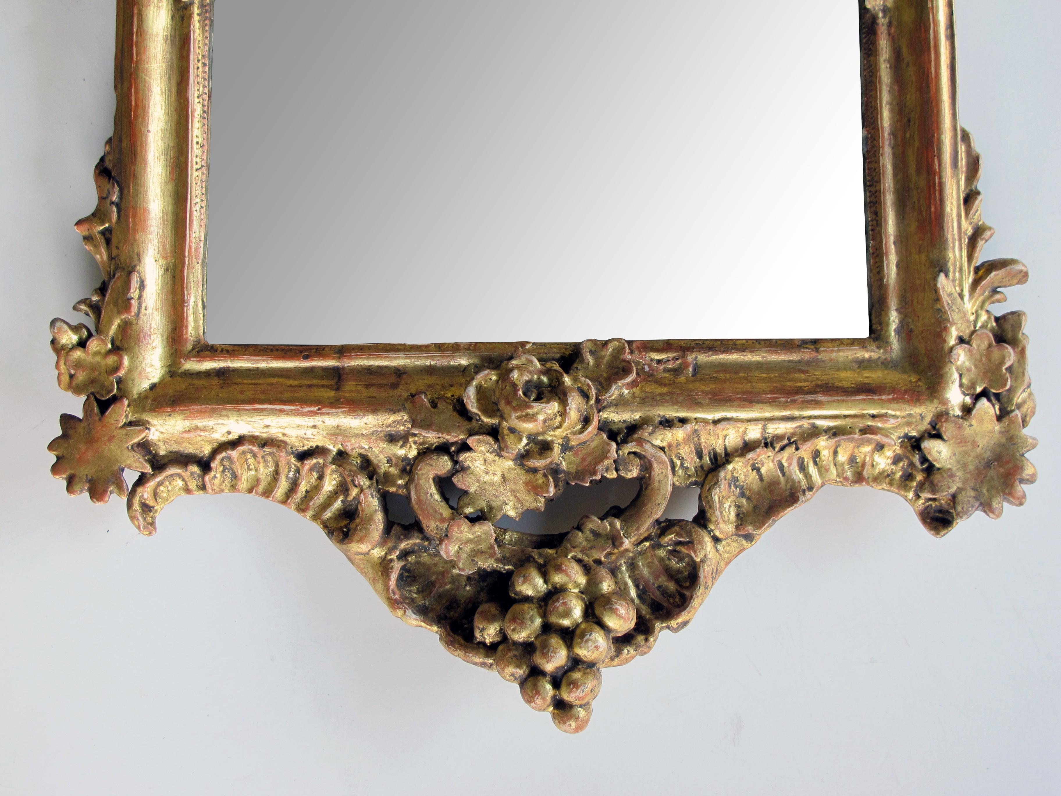 Mid-18th Century Ornately Carved French Rococo Gilt-wood Mirror with Exuberant Crest For Sale