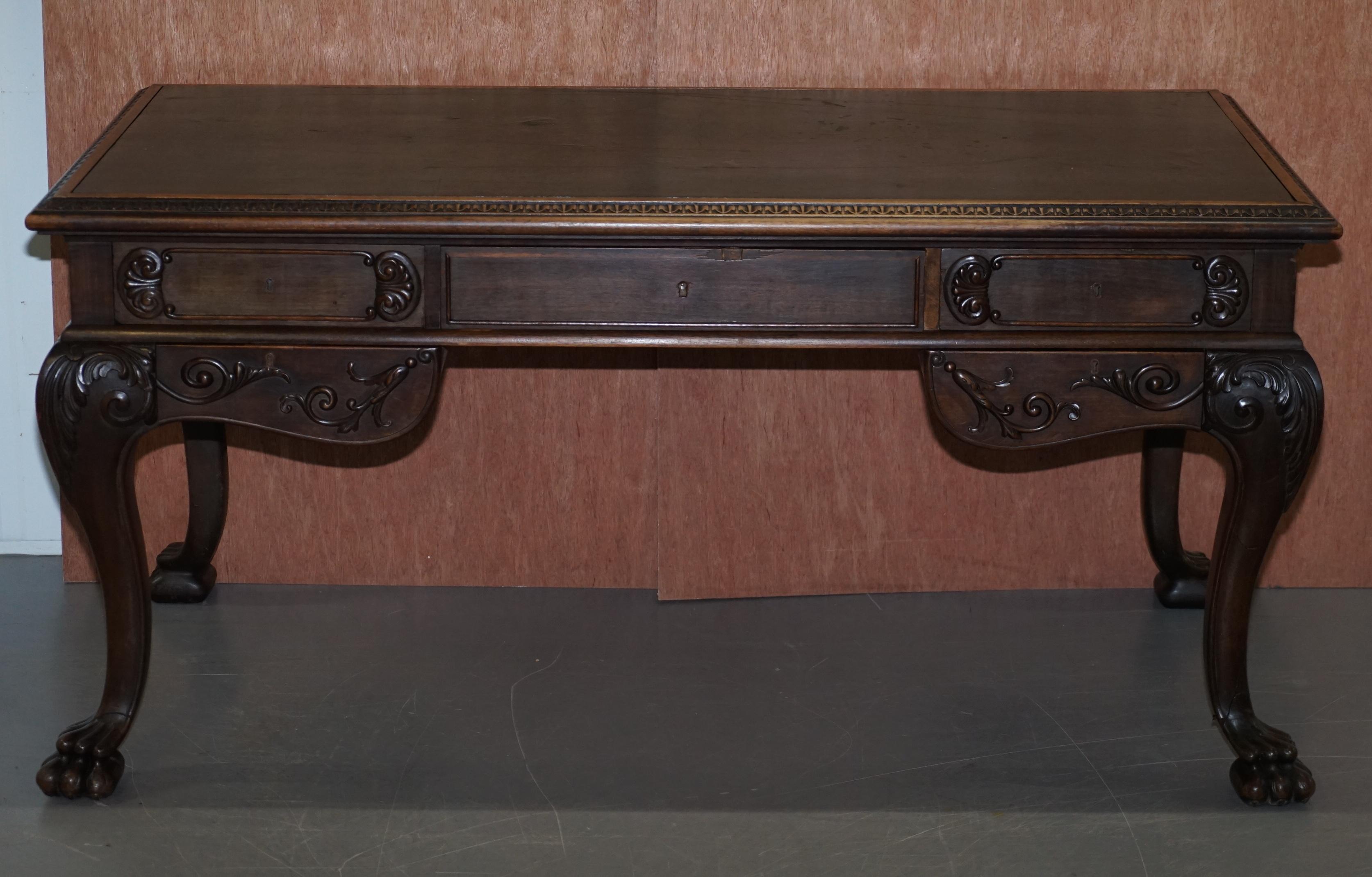 We are delighted to offer for sale this lovely oversized ornately hand carved writing desk with green leather top

A good looking, well made and decorative desk, with lovely hand carved lion hairy paw feet, a thick green leather writing surface,