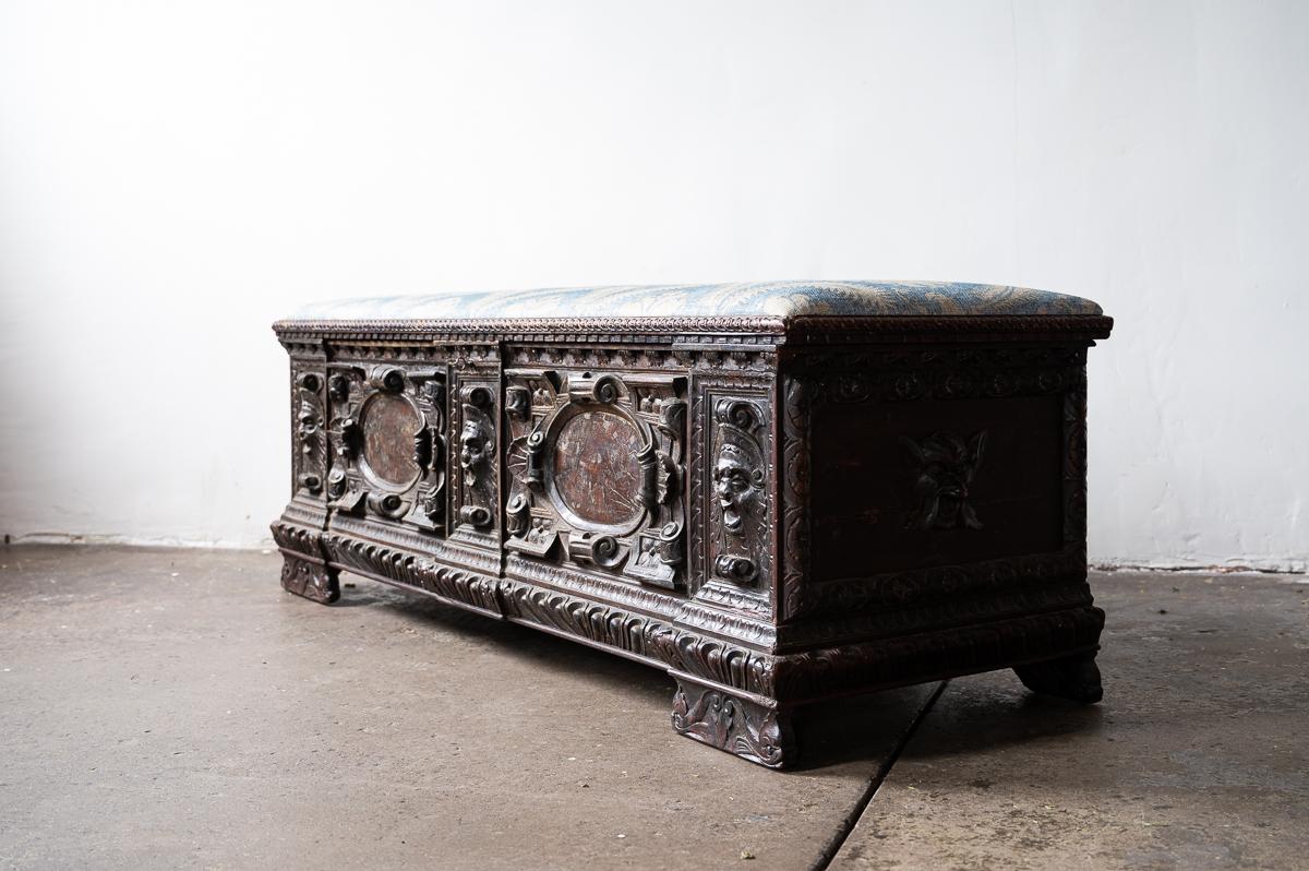 Ornately carved wooden Italian Cassone chest newly upholstered in Robert Kime fabric.