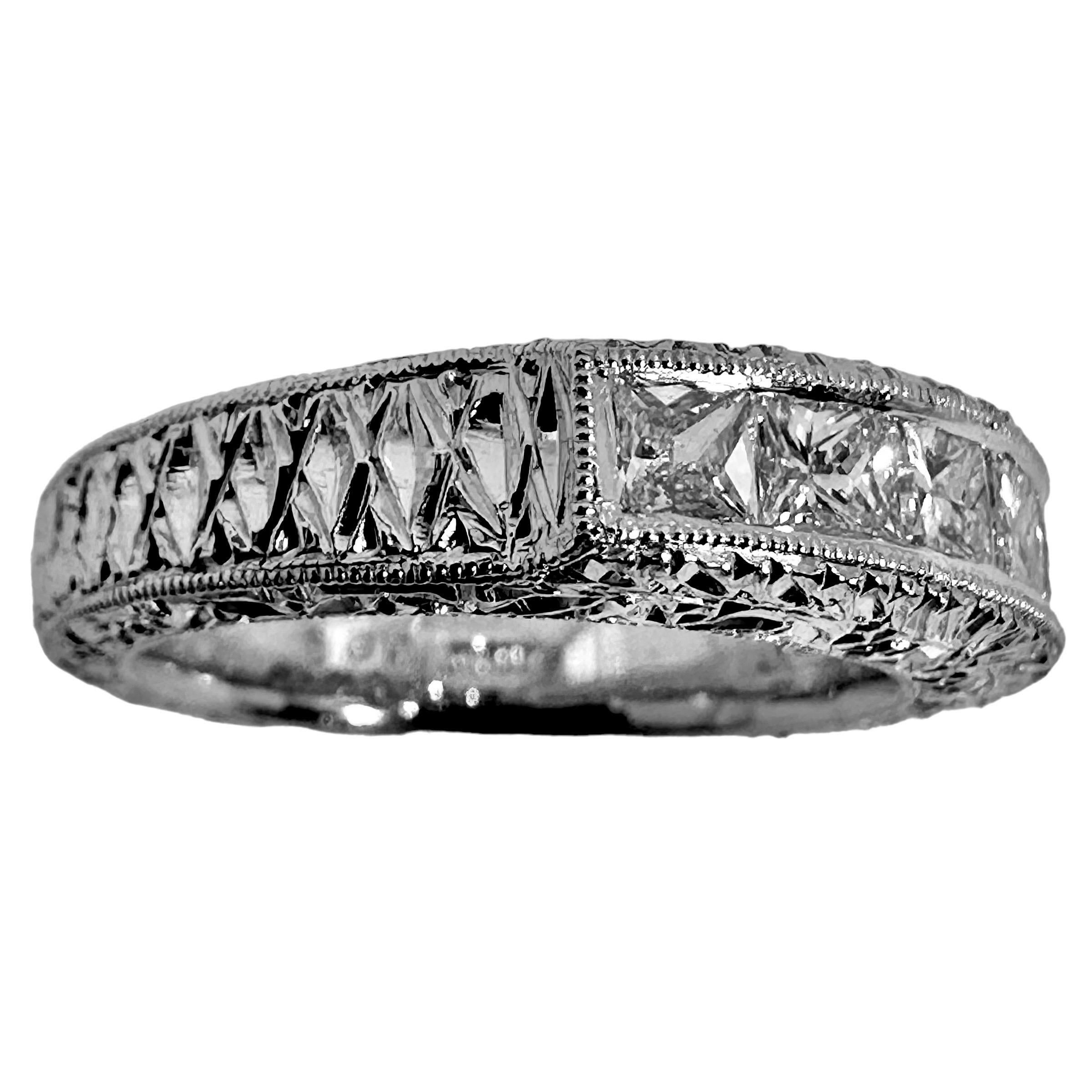 This unique platinum wedding band is set with a line of seven fine quality princess cut diamonds across the top that are framed by artfully executed mill grain edging. While actually a modern ring, it does exude all of the style and quality of fine