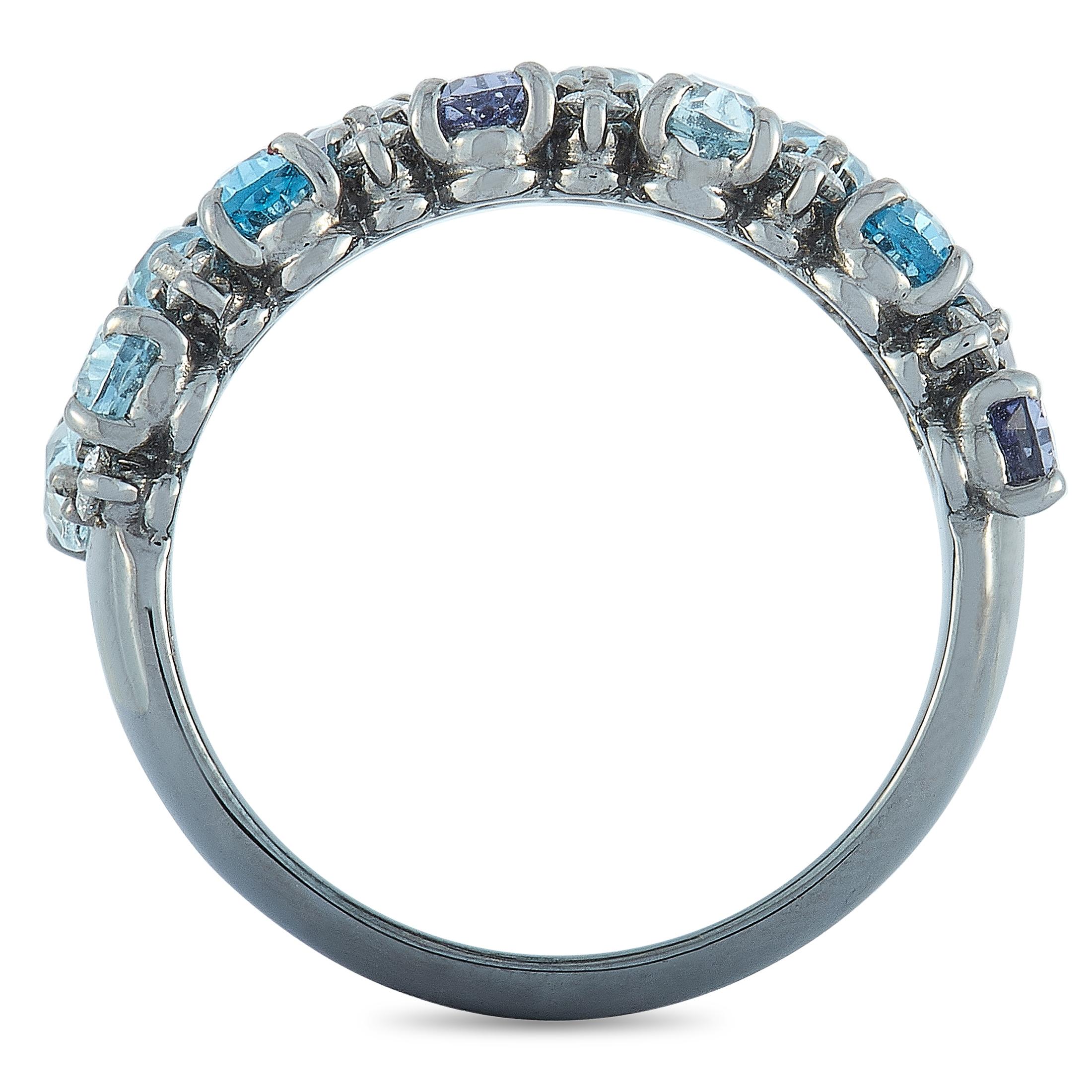 This Oro Trend ring is made of 18K white gold and weighs 6 grams, boasting band thickness of 3 mm and top height of 3 mm, while top dimensions measure 22 by 8 mm. The ring is embellished with aquamarine, iolite and topaz stones, and with a total of