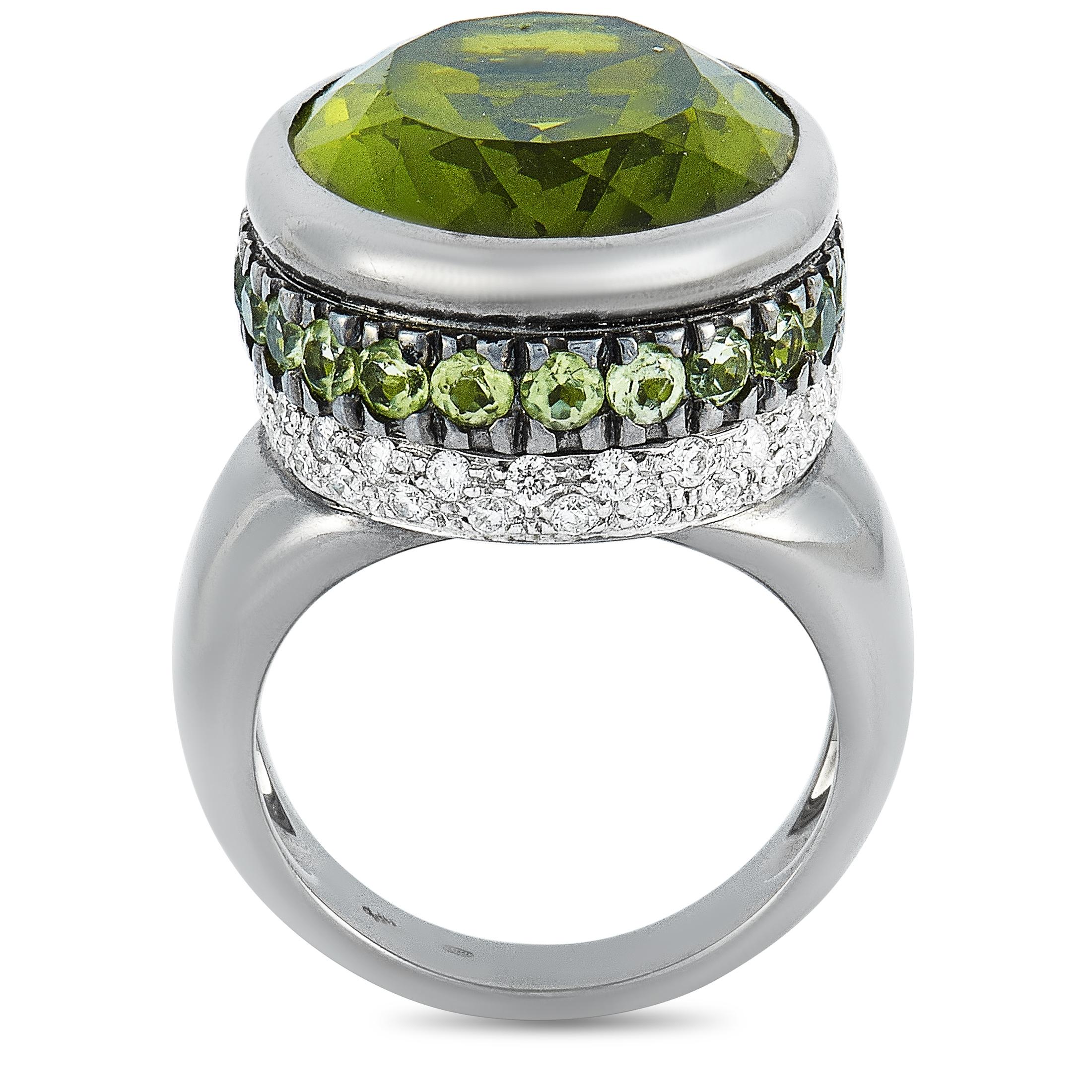 This Oro Trend ring is made of 18K white gold and weighs 20.7 grams, boasting band thickness of 4 mm and top height of 12 mm, while top dimensions measure 18 by 22 mm. The ring is embellished with peridots and a total of 0.69 carats of diamonds.
 
