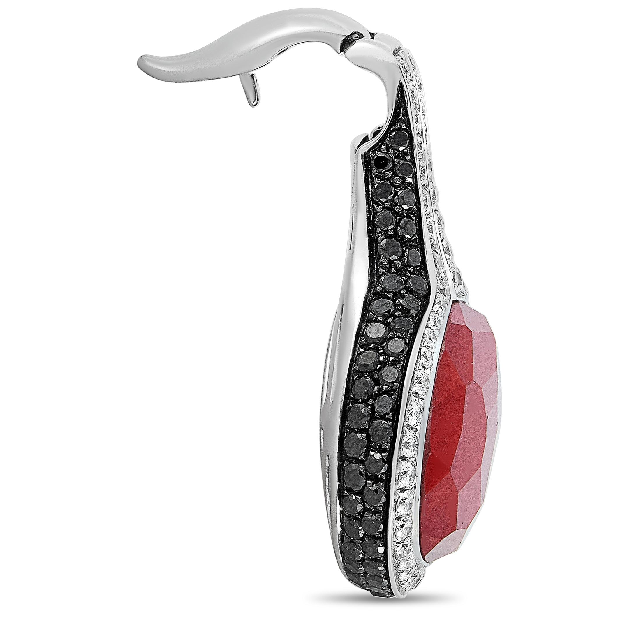 This Oro Trend pendant is crafted from 18K white gold and weighs 18.1 grams, measuring 1.50” in length and 1.12” in width. The pendant is embellished with a carnelian and with white and black diamonds that total 1.18 and 2.16 carats respectively.
 
