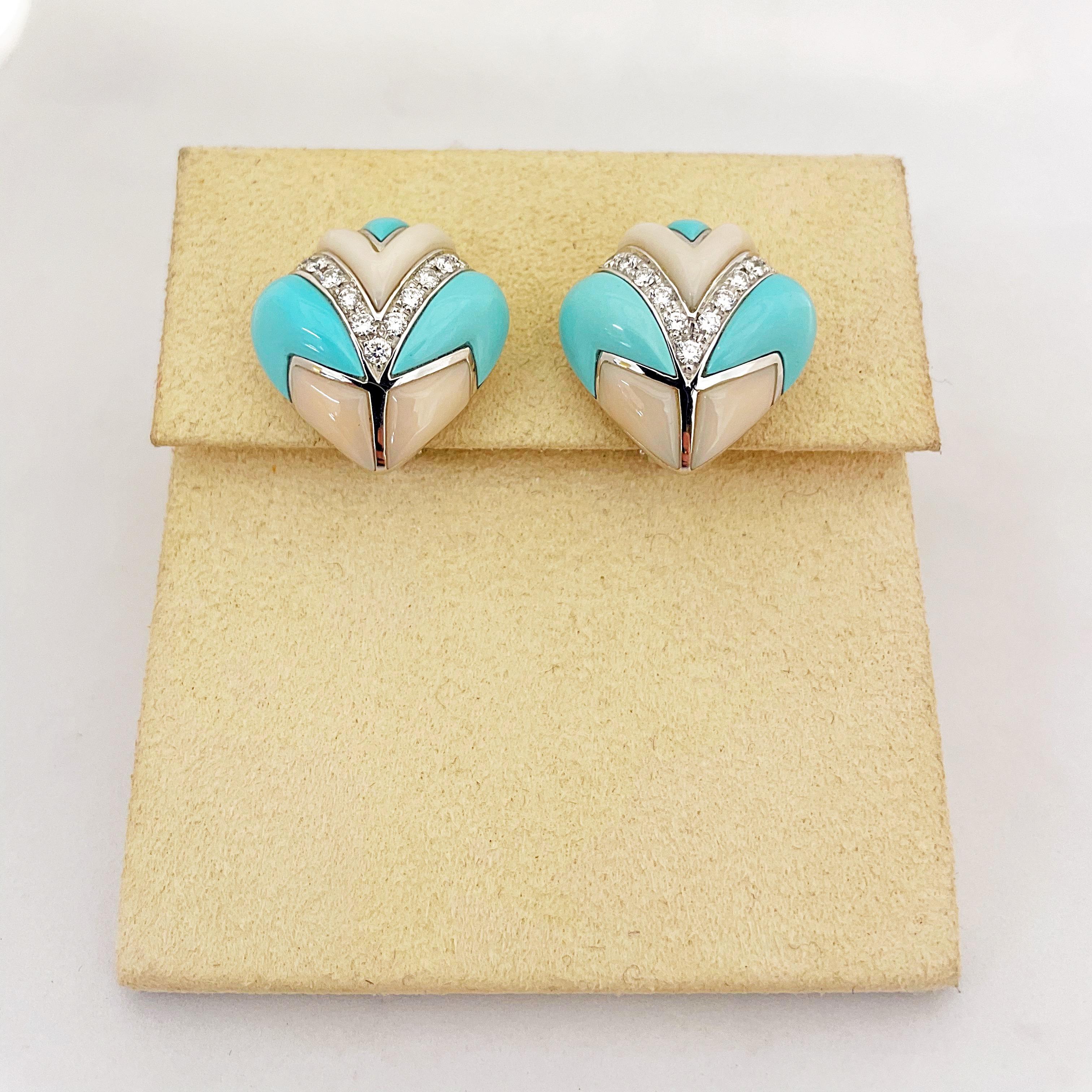 These stunning 18KT white gold  earrings were designed by renowned Italian Jewelers Oro Trend  for Cellini Jewelers. They have a strong Art Deco influence with their inlaid angular stones in turquoise and a very pale pink coral.The center is set