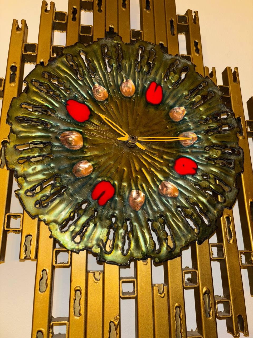 This is a superb brutalist inspired wall clock made of metal and a enalmed face by franco bastianelli for studio laurane circa 1960’s. 
It is hand made and in very good working condition. 
It is battery operated so no cords or wires.
 It is truly a