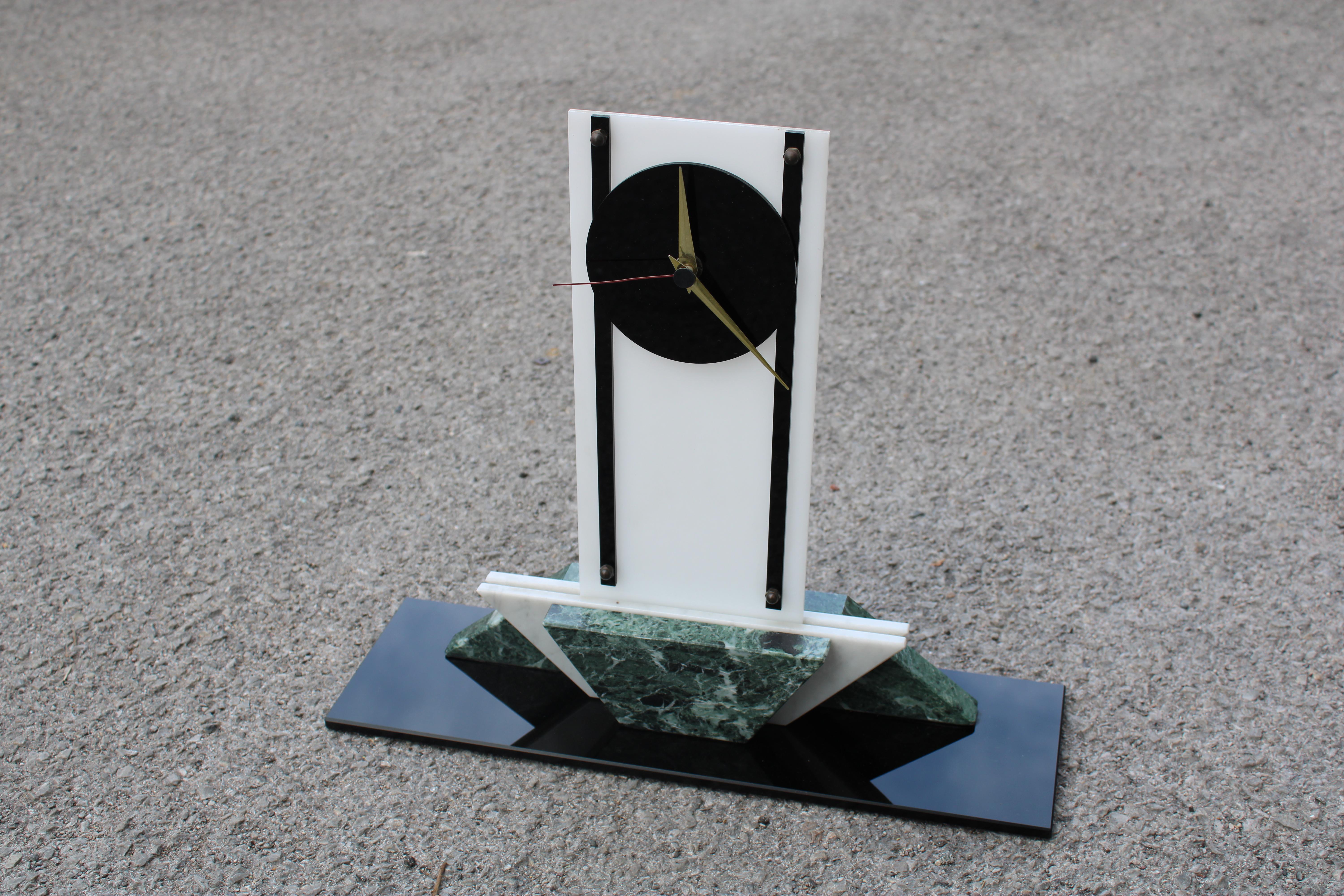 Art deco style clock made of different marbles white plexiglass and black glass, the machine was replaced with a battery operated one over time.