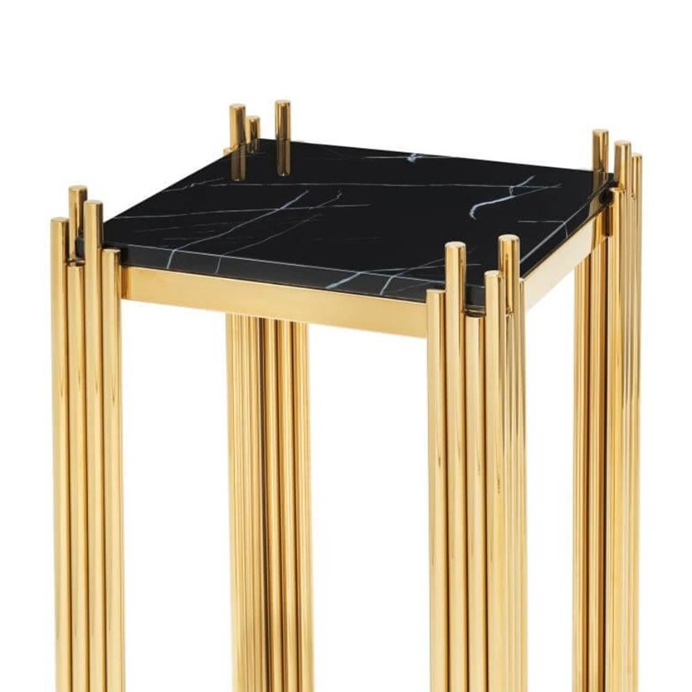 Side table ororods high with structure
in steel in gold finish and with black marble top.