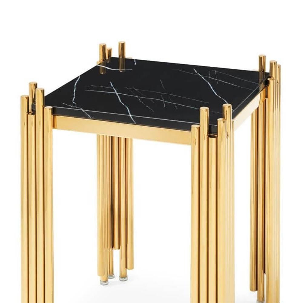 Side table Ororods medium with structure 
in steel in gold finish and with black marble top.