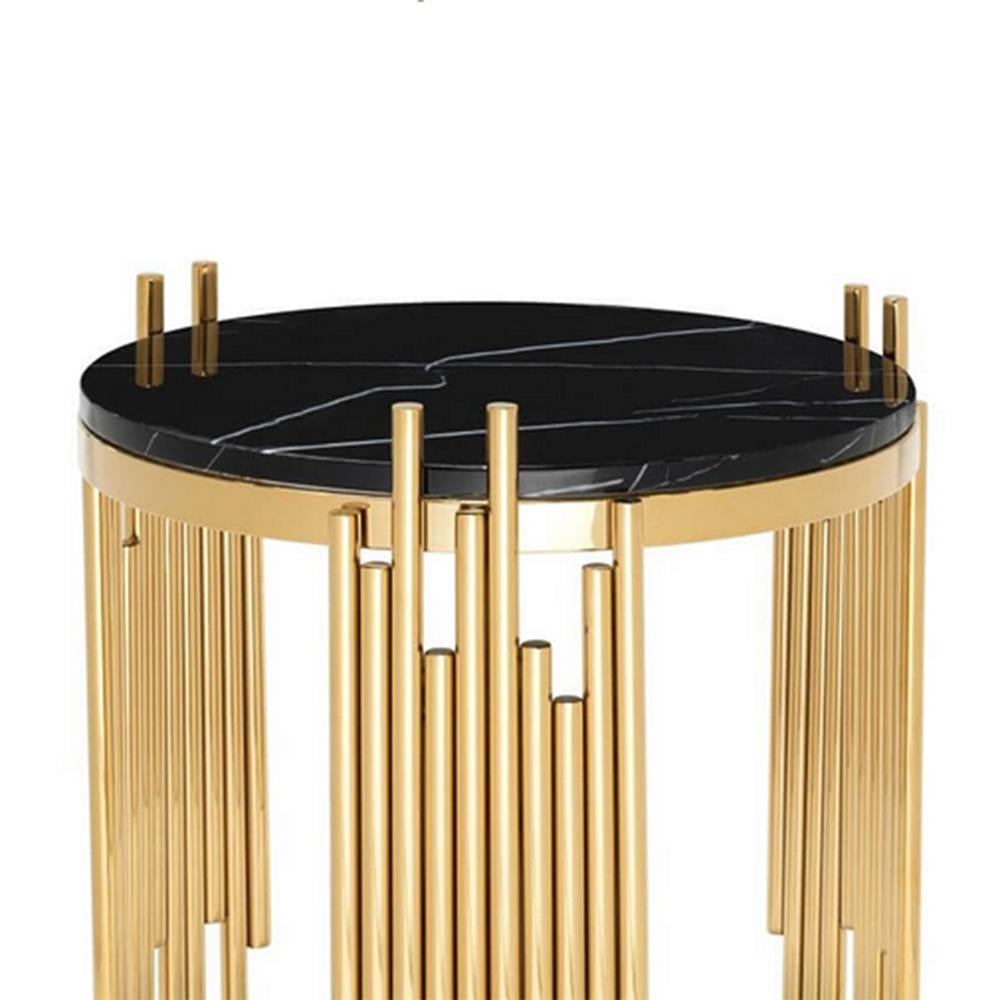 Side table Ororods round with steel structure in
gold finish and with black marble top.