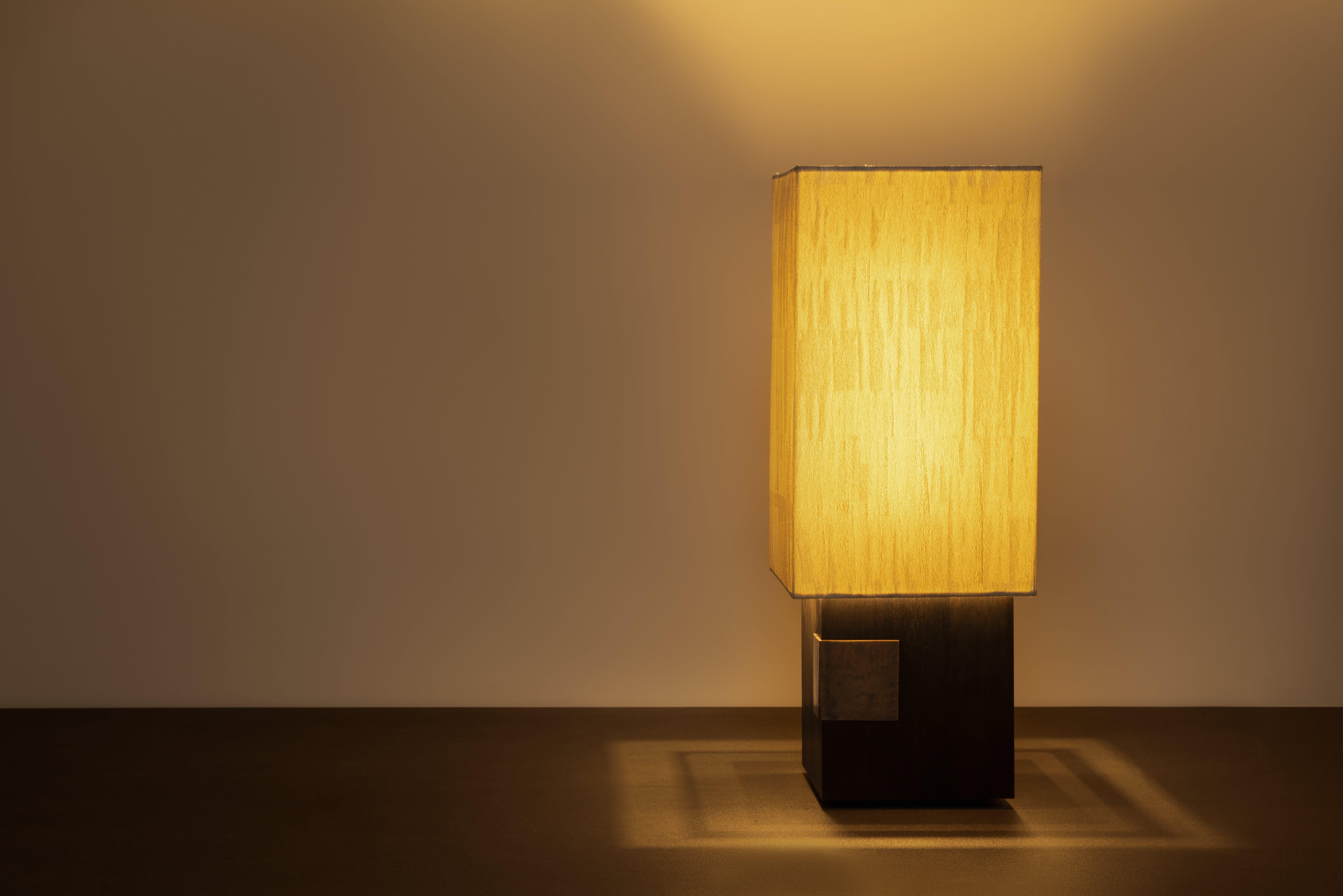 Orphée Noir Table Lamp by Arch Plus Ultra
Dimensions: W 30 x D 30 x H 78 cm.
Materials: Ebony wood, Cast bronze, Jacquard of trevira.

Table lamp with base in top-quality African ebony wood certifi cated by CITES. The bronze detail functions as a