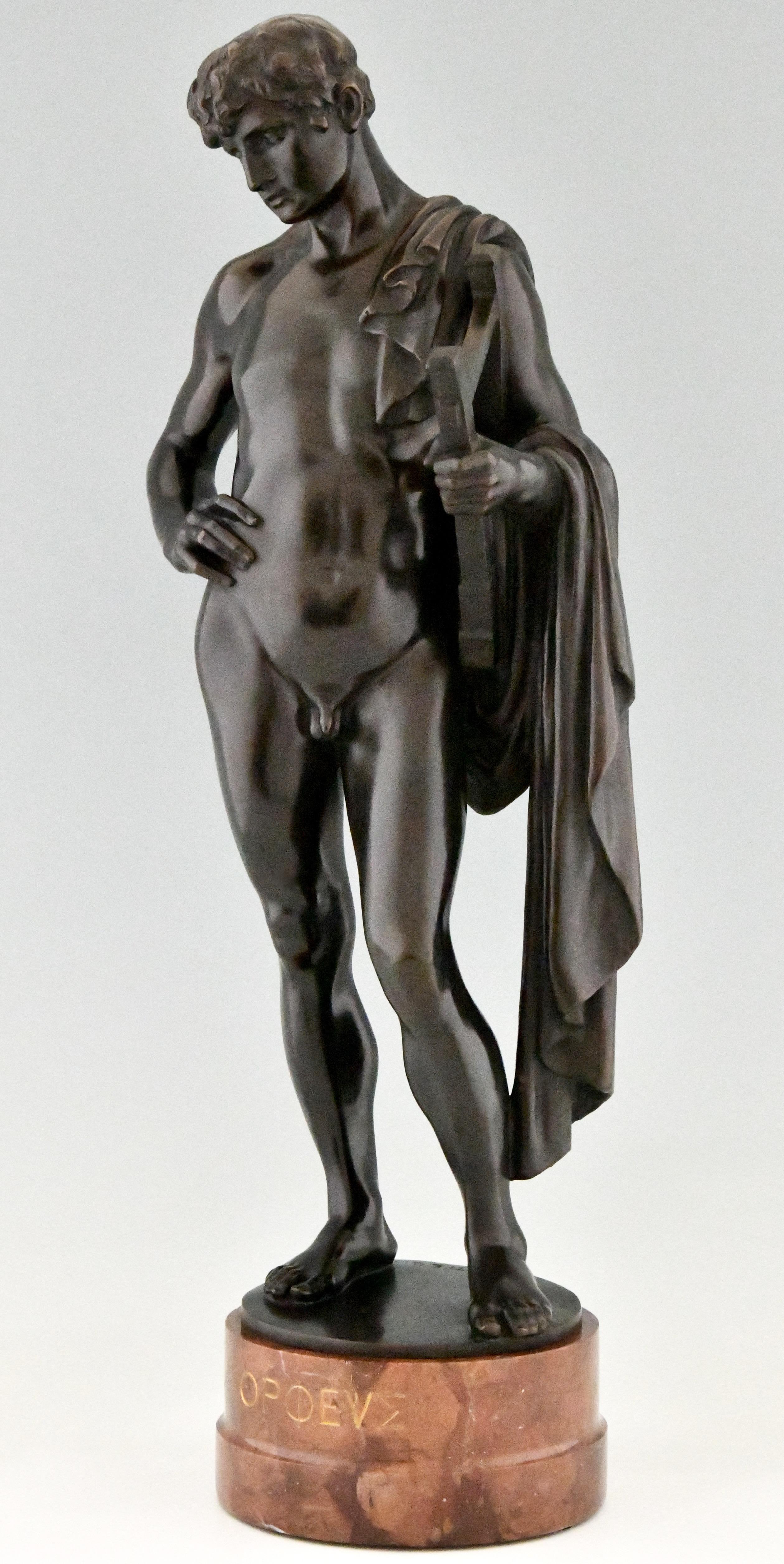 Orpheus, tall Antique bronze sculpture of a male nude with lyre and cape. By Prof. George Mattes. 1874-1942. Germany ca. 1900. Patinated bronze on a circular marble base.
