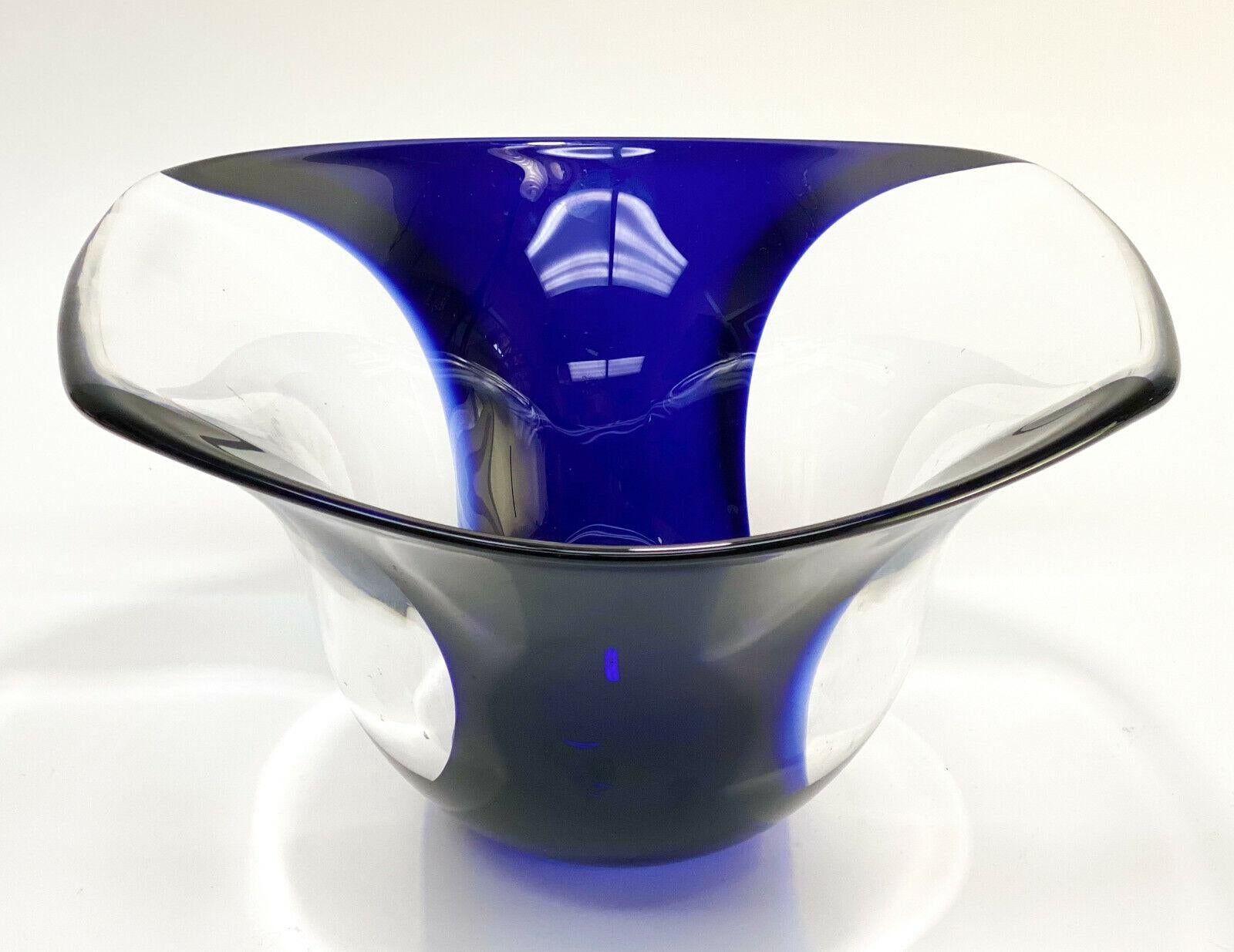 Orrefors Art Glass Cobalt blue & clear bowl by Lars Hellsten, #931620

A fluted opening with a curved cobalt blue stripe. Orrefors mark to the underside base and signed Lars Hellsten.

Additional Information:
Origin: Scandinavia 
Type of