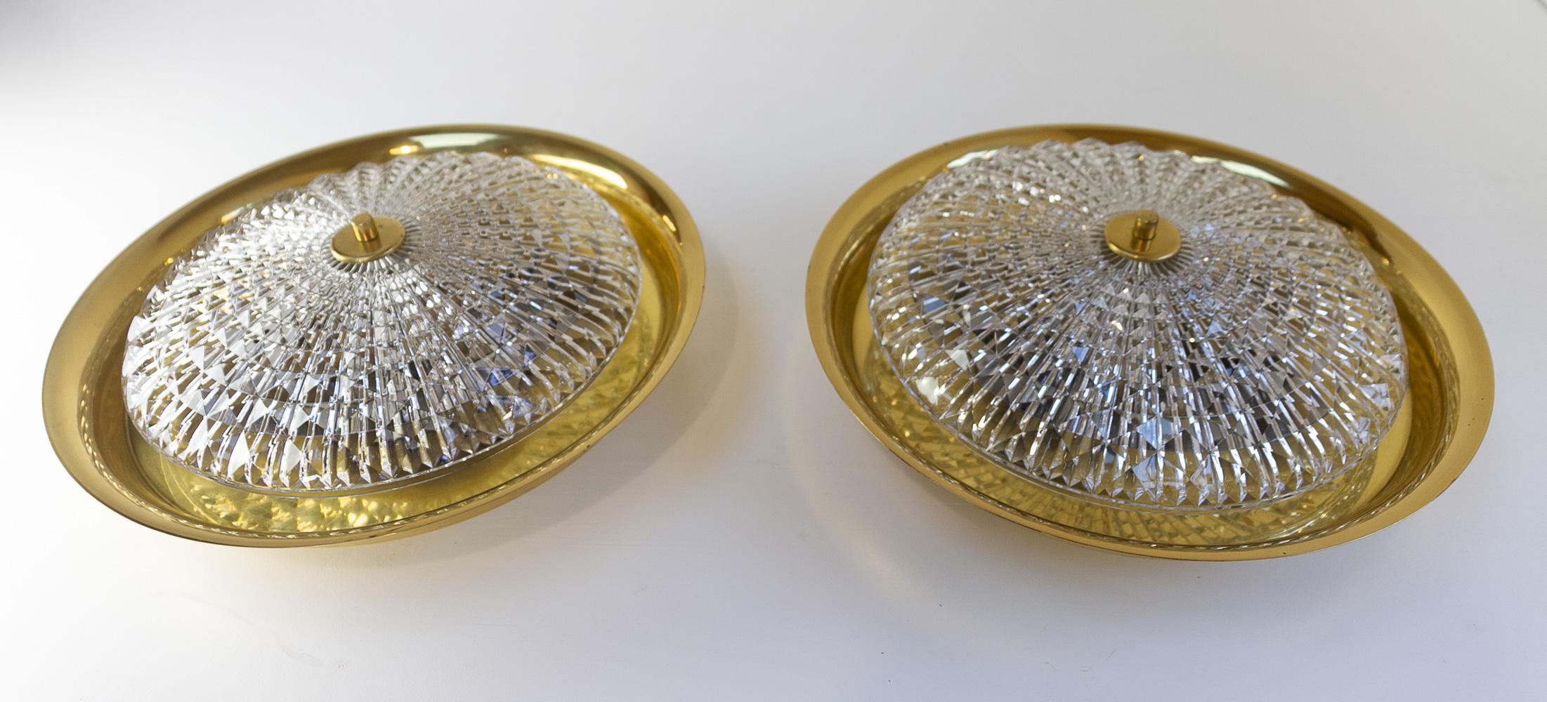 Orrefors Wall or Ceiling Lamps by Fagerlund for Lyfa, 1960s. Set of 2.
Pair of Scandinavian Mid-Century Modern lights with clear textured thick crystal shade and brass body.
Produced by Lyfa Denmark, designed by Carl Fagerlund and crystal glass