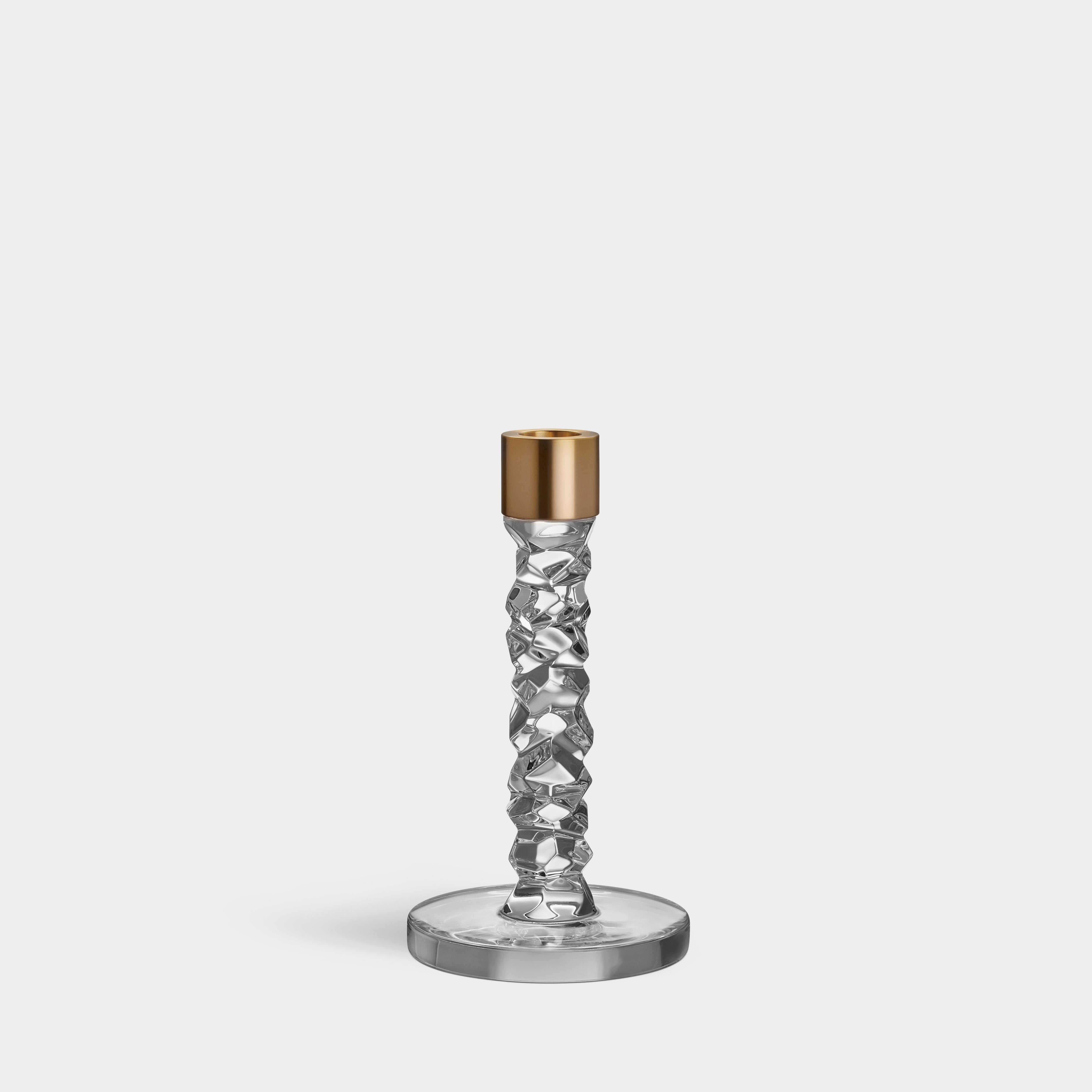 The Carat collection is based on a contemporary interpretation of the traditional cut glass for which Orrefors is world-renowned. The irregular geometry produces beautiful reflections of light in the crystal. The small candlestick in clear glass is