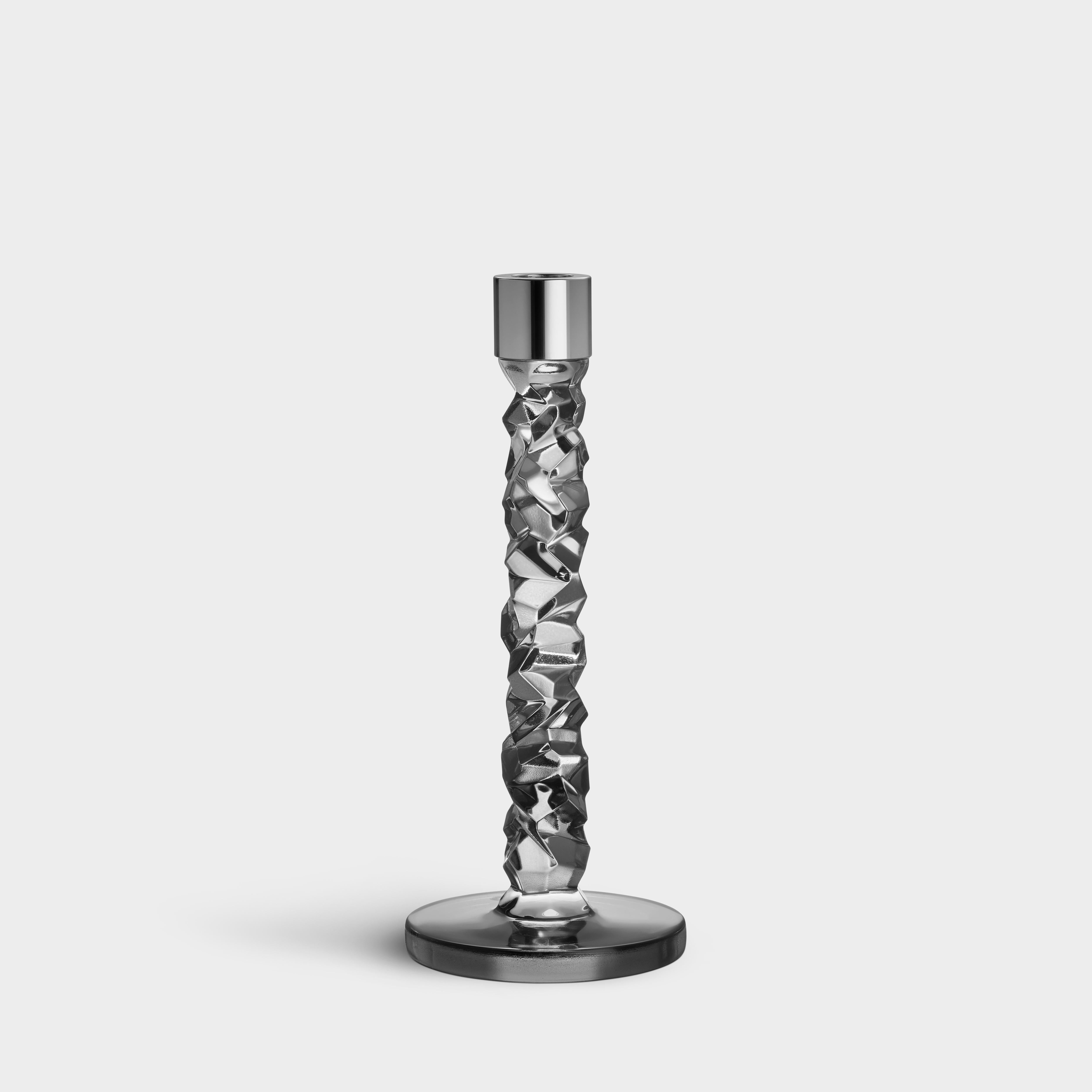 The Carat collection is based on a contemporary interpretation of the traditional cut glass for which Orrefors is world-renowned. The irregular geometry produces beautiful reflections of light in the crystal. The medium candlestick in the color