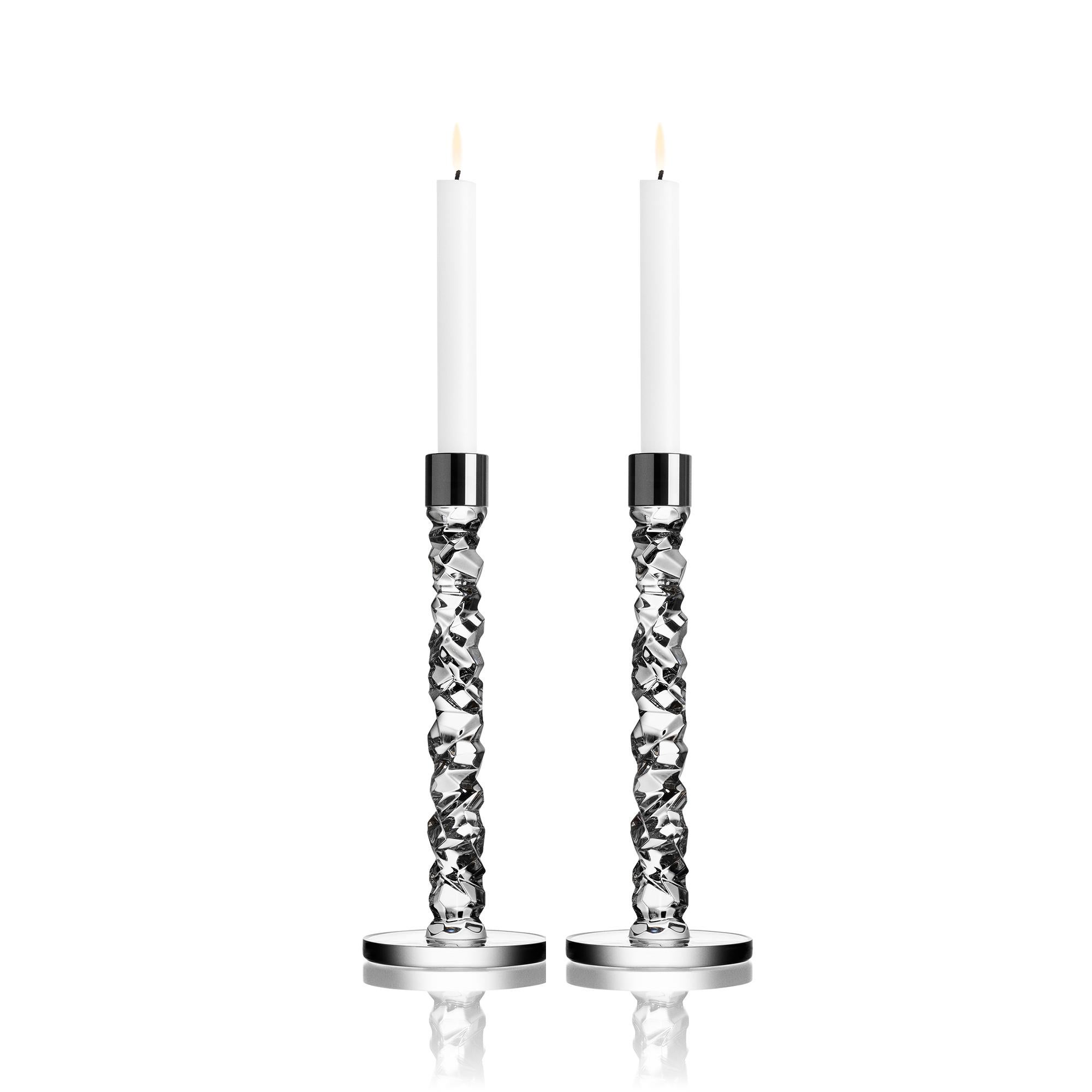 The Carat collection is based on a contemporary interpretation of the traditional cut glass for which Orrefors is world-renowned. The irregular geometry produces beautiful reflections of light in the crystal. The large candlestick in clear glass is