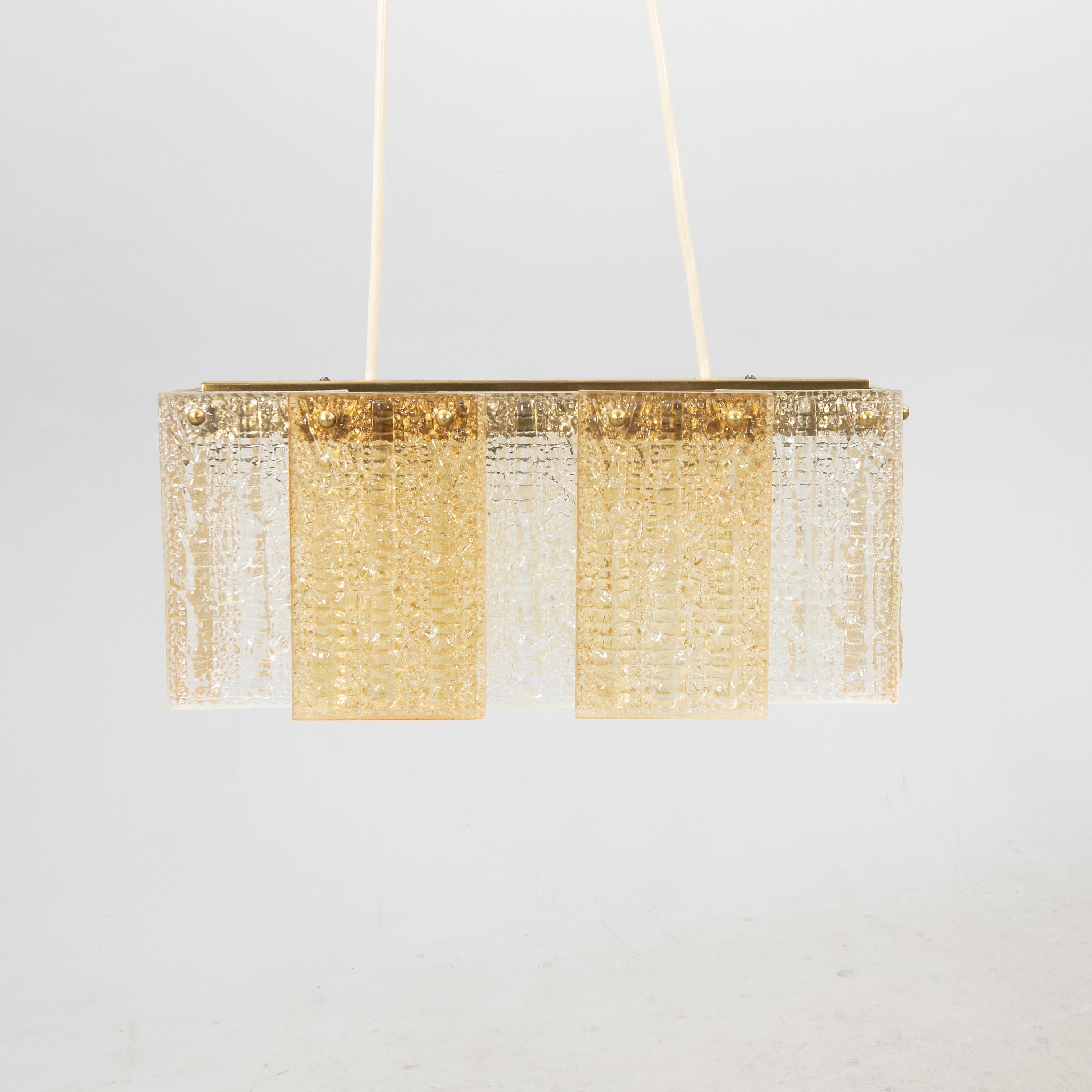 Ceiling pendant glass and brass made by Orrefors, Sweden, 1960
Rare model made of glass plates, of different colors, beautifully mounted with nice details on a brass structure.
The height can be adjusted according to the length of the wires 
In