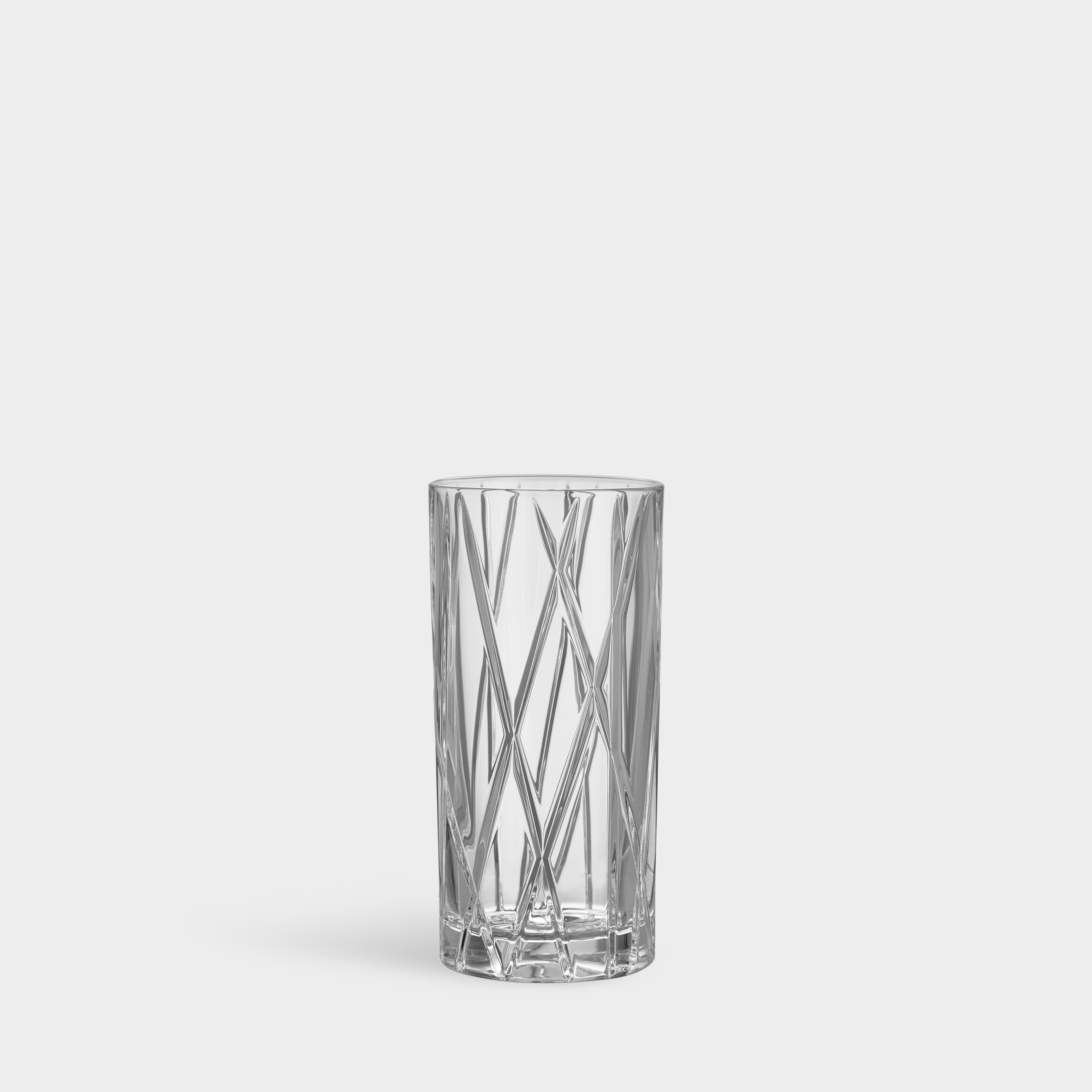 City Highball from Orrefors holds 12 oz and is ideal for serving long drinks, with or without alcohol. The cuts that criss-cross the surface of the glass create an asymmetric look, which contributes to the distinct identity of the collection.