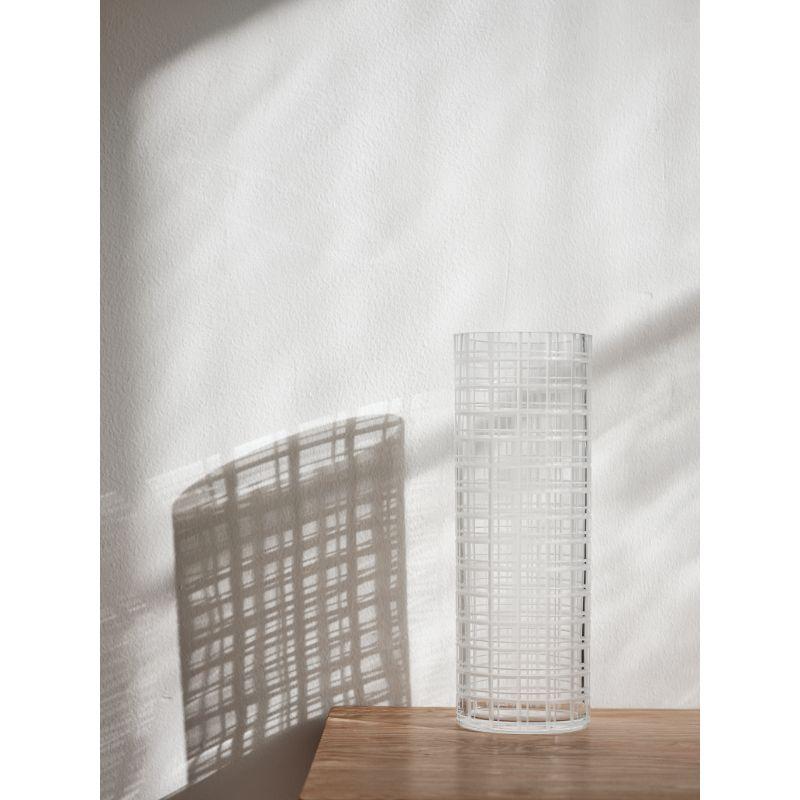 The tall cylinder vase with a check motif in the Cut In Number collection from Orrefors is ideal for long stem flowers. The satin finished cuts on the vase beautifully emphasize the transparency of the clear crystal. Designed by Ingegerd Råman.
