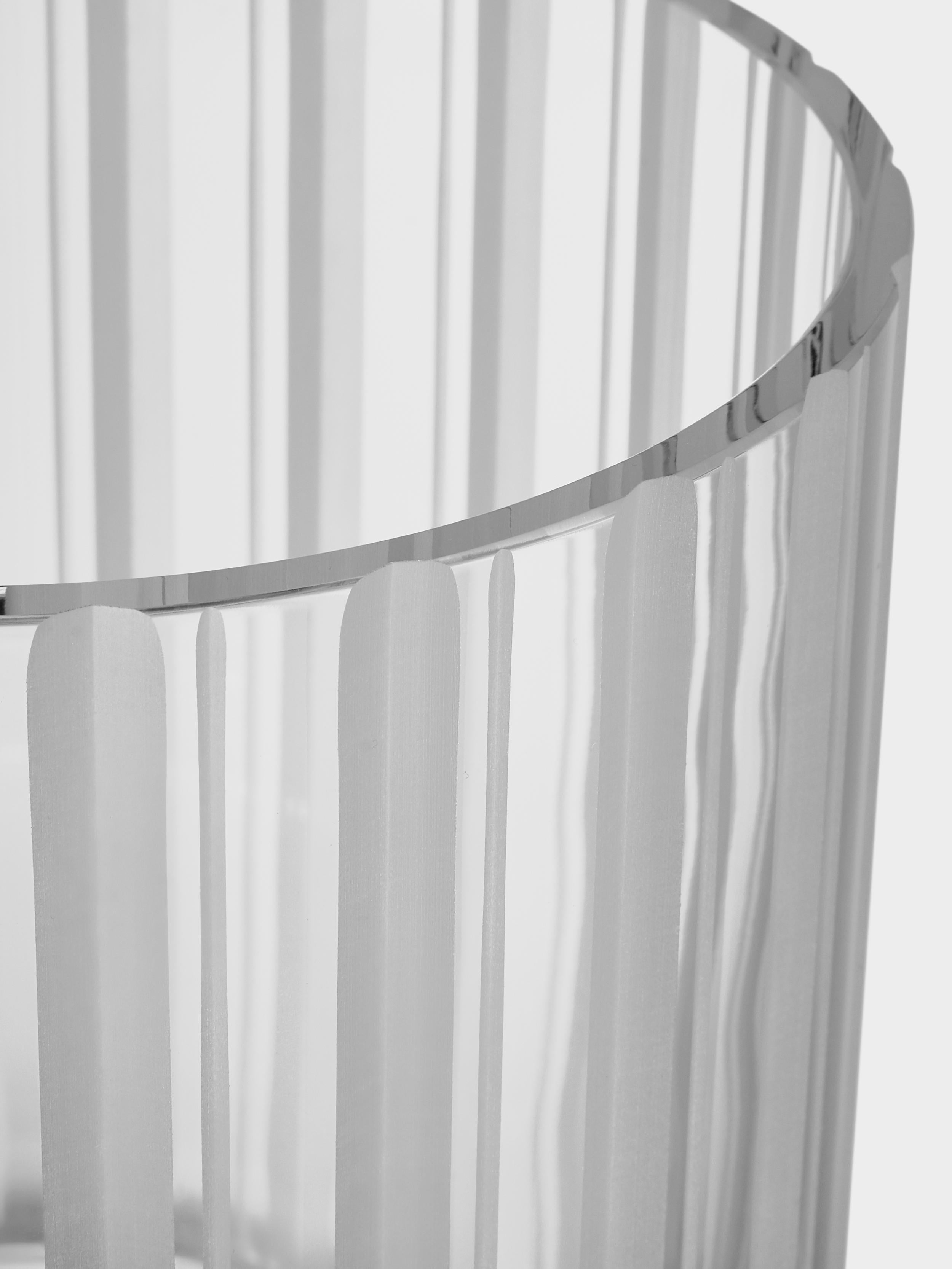 The low cylinder vase with a stripe motif in the Cut In Number collection from Orrefors is ideal for top-heavy floral arrangements. The satin finished cuts on the vase beautifully emphasize the transparency of the clear crystal. Designed by Ingegerd