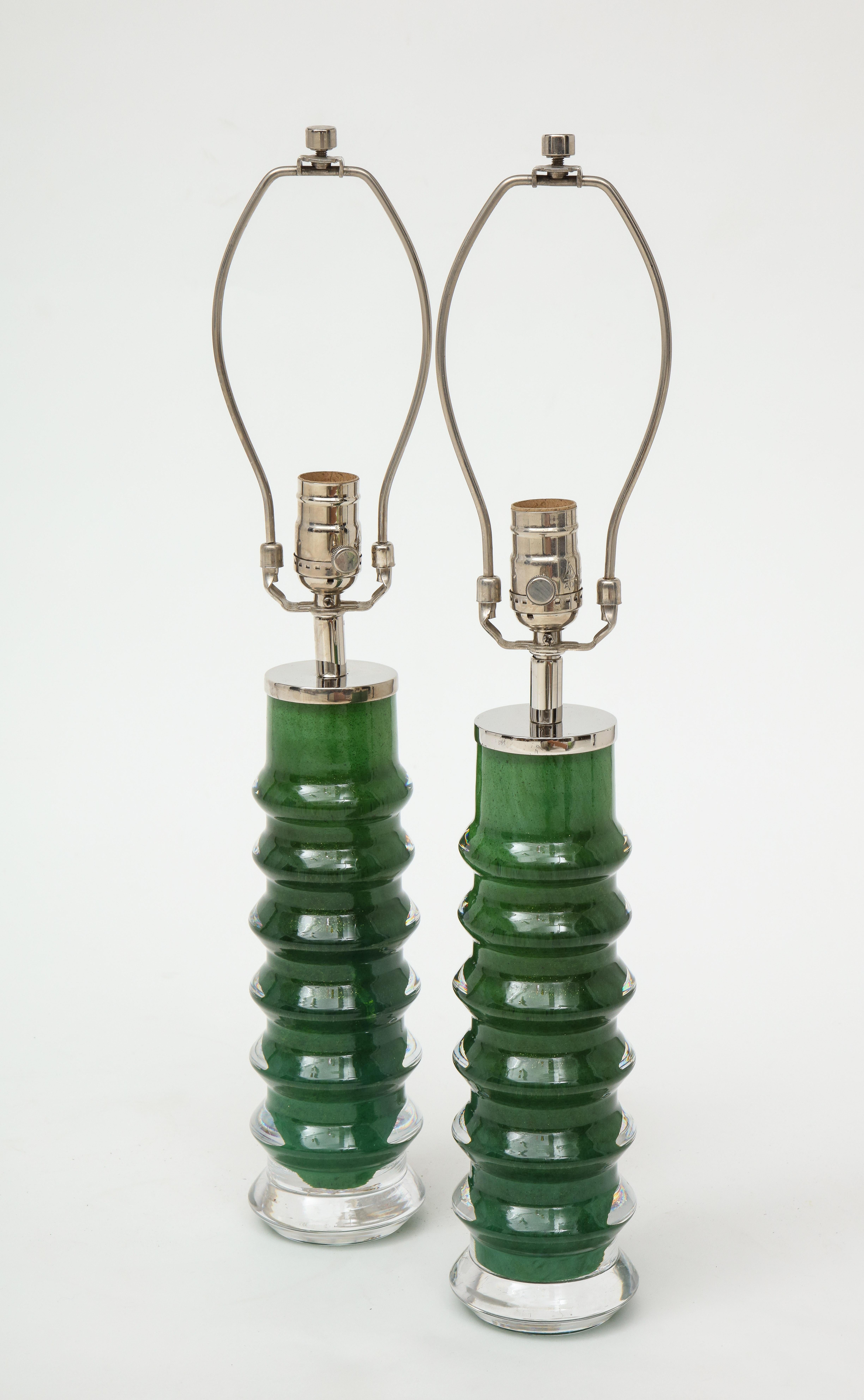 Pair of rare color and form Emerald Green glass crystal lamps with polished nickel hardware. Signed. Rewired for use in the USA. Glass portion is 12.50 inches tall.