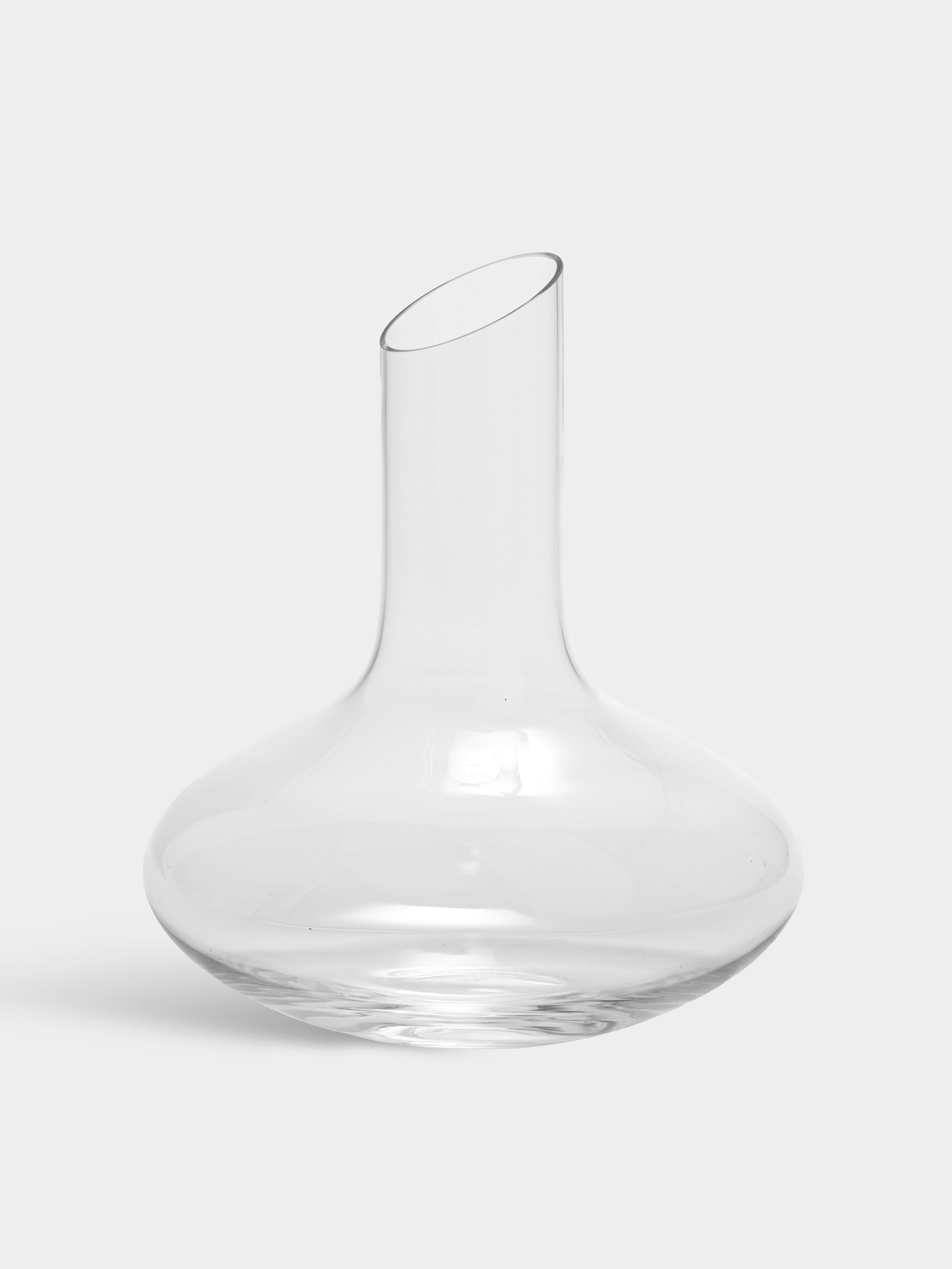Enjoy Decanter from Orrefors, holding 34 oz, has a bowl-shape with a tapered neck, making it ideal for serving wine, as well as water. With its generous size and large diameter at the widest point, this carafe is well-suited for decanting wine.
