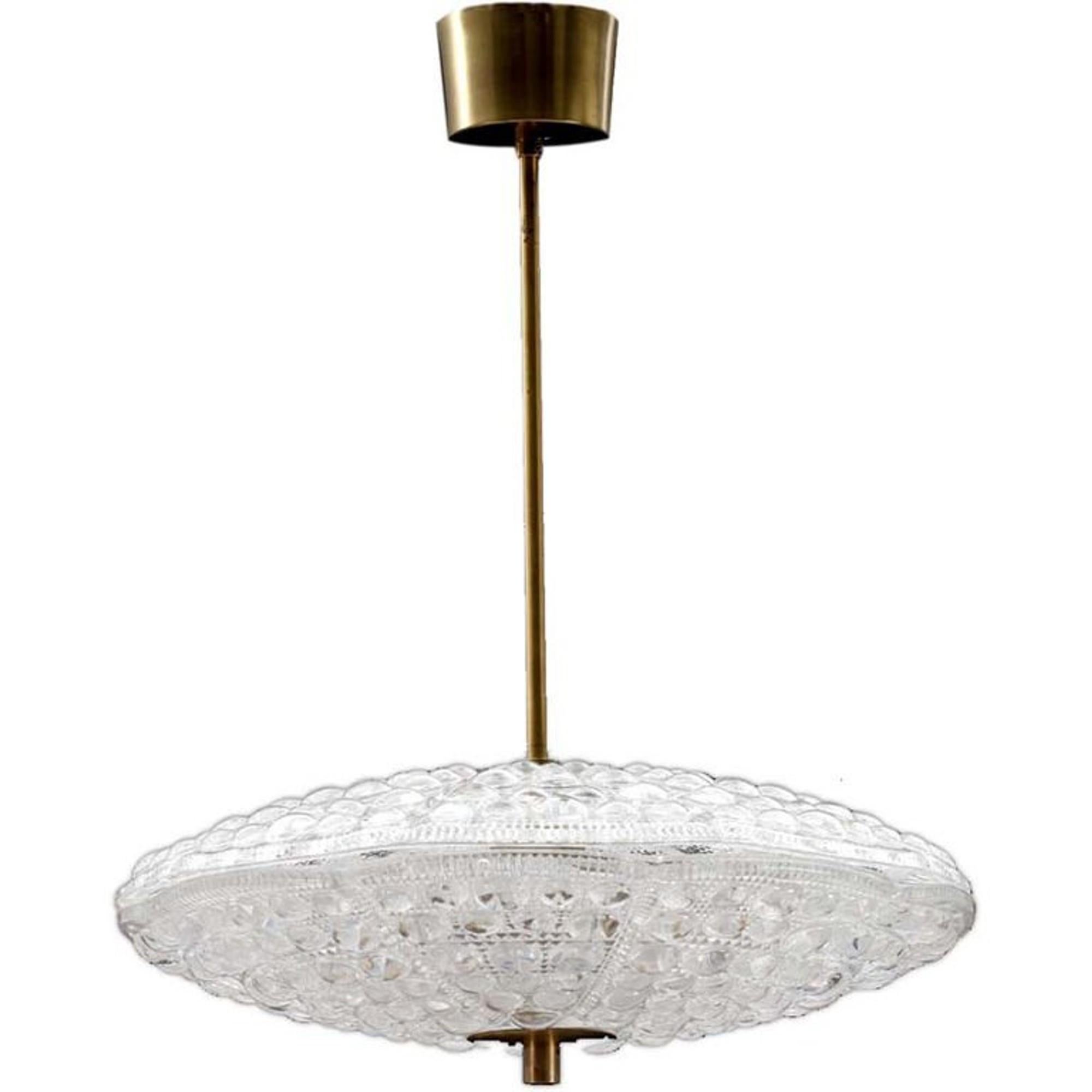 Pair of Flying Saucer shaped chandelier in two pieces. Beautiful textured glass with brass fittings. Designed by Carl Fagerlund for the Swedish glass maker Orrefors.
Takes five candelabra basebulbs.

Existing old wiring, rewiring complementary, let