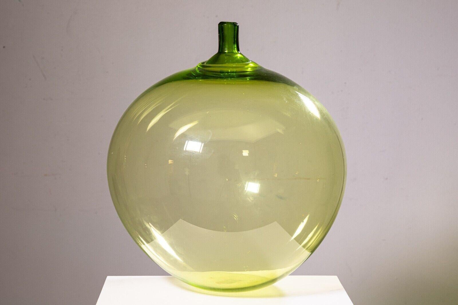 An Orrefors green apple vase by Ingeborg Lundin. This gorgeous glass vase is designed by Swedish designer Ingeborg Lundin for Orrefors, a designer glassworks company out of Smaland, Sweden. This piece was designed and manufactured in the 1950s. It
