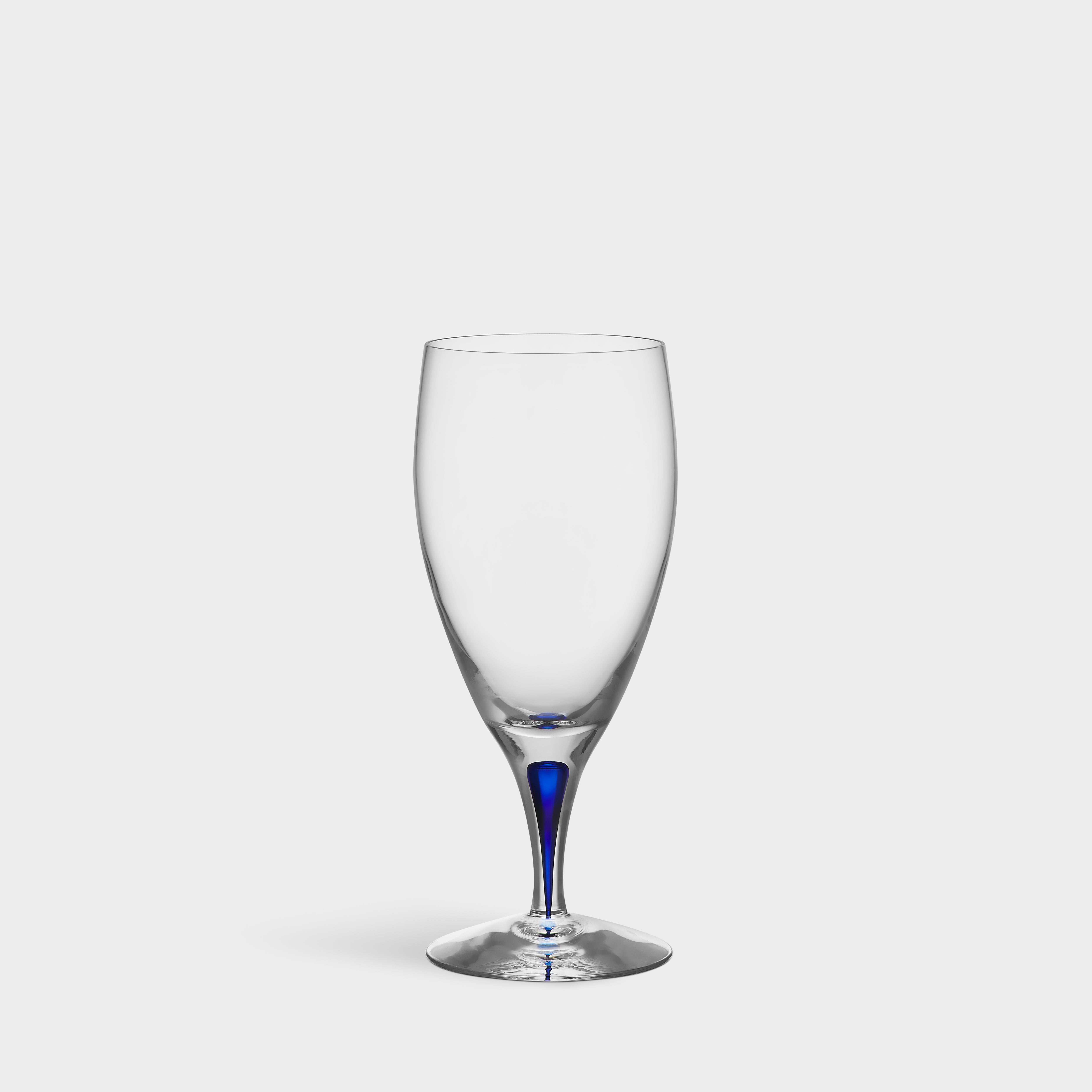 Intermezzo Ice Beverage from Orrefors was designed in 1984. The glass holds 15 oz and is mouth-blown in Sweden by expert glassblowers. Intermezzo Ice Beverage has a drop of blue sealed inside the stem – an innovation based on traditional
