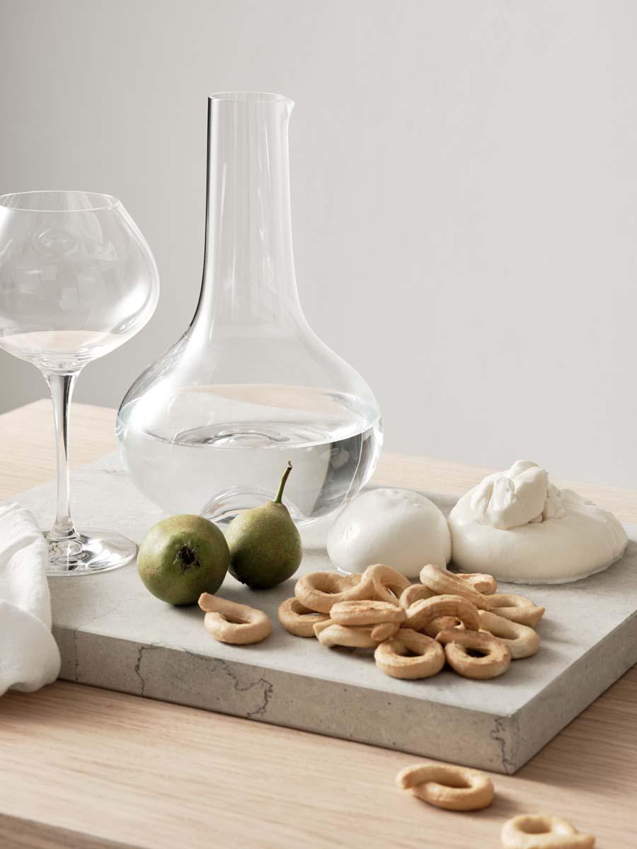 More Carafe from Orrefors holds 50 oz and is intended for both water and wine. Aerate wine in the carafe by filling it to the widest point. The carafe has an indented bottom, which provides a good grip for serving beverages. Designed by Erika
