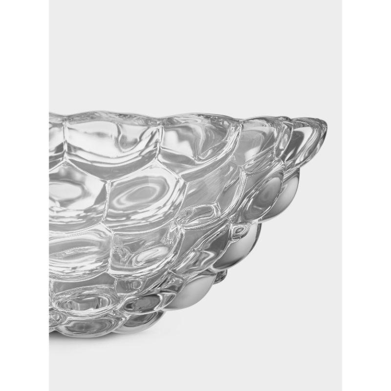 Raspberry is a beloved Orrefors classic. The small bowl in clear crystal has a design resembling a raspberry with its round ‘drupelets’ giving it a soft look. It is ideal for serving appetizers or simply as a decorative object on its own. Designed