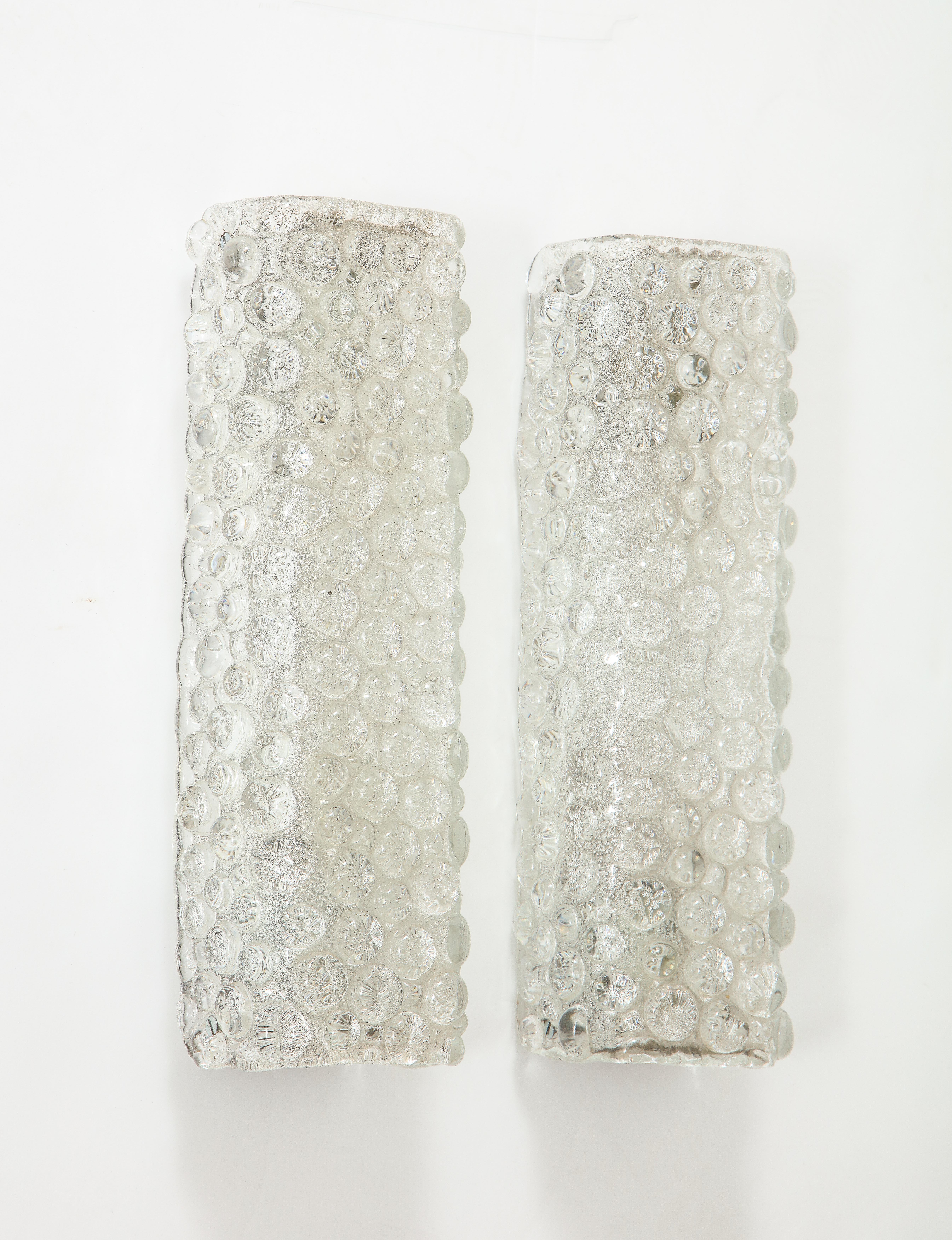 Pair of Scandinavian Modern rectangular form crystal sconces with a frosty interior, smooth raised dot exterior. Each sconce has 2 sockets, Rewired for use in USA.