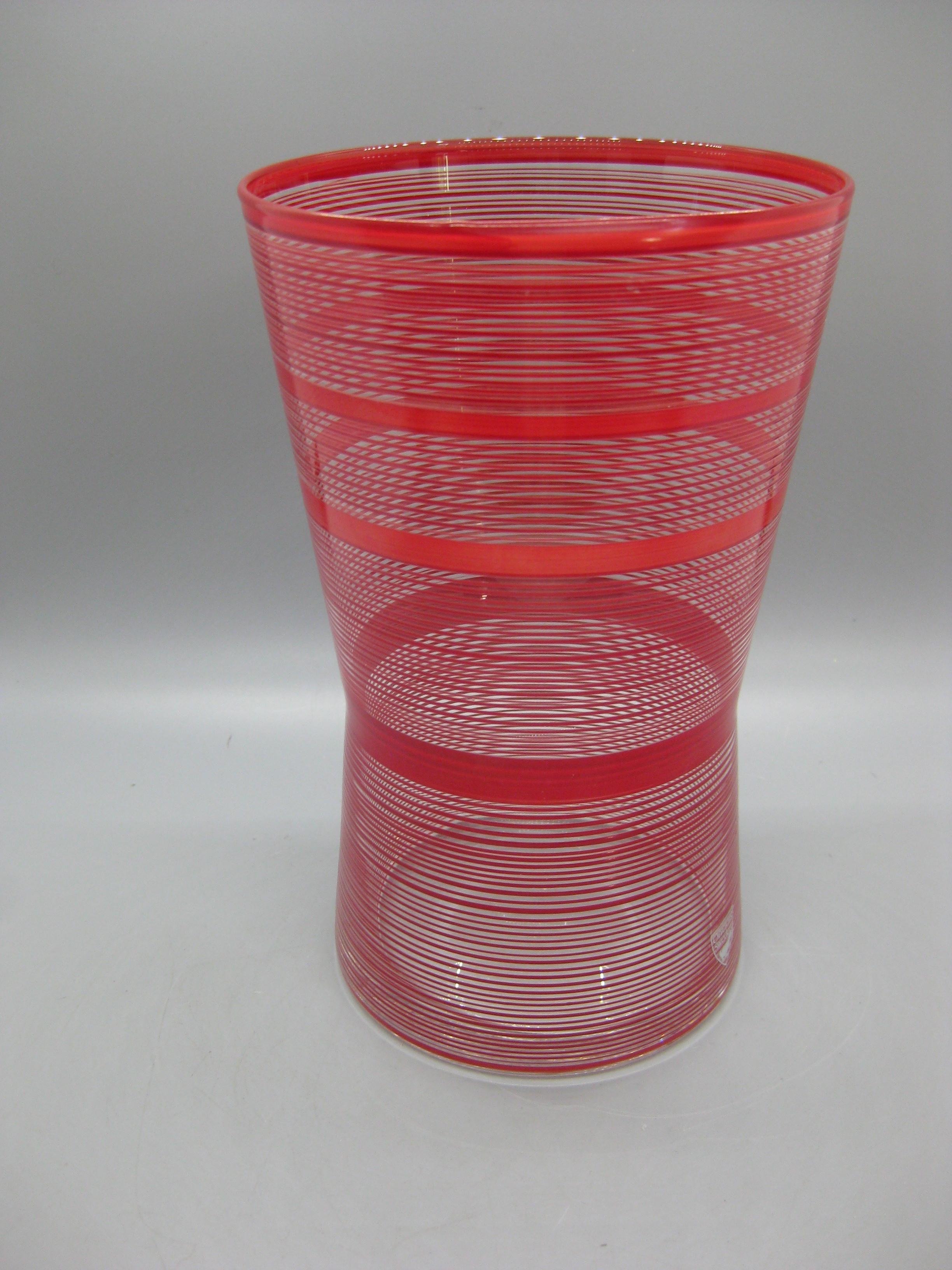 Beautiful Orrefors red striped art glass vase. Designed by Ingegend Raman and was made in Sweden. The vase appears to have never been used. Signed on the bottom and has the original tag on the lower edge. In excellent condition. Color is great and
