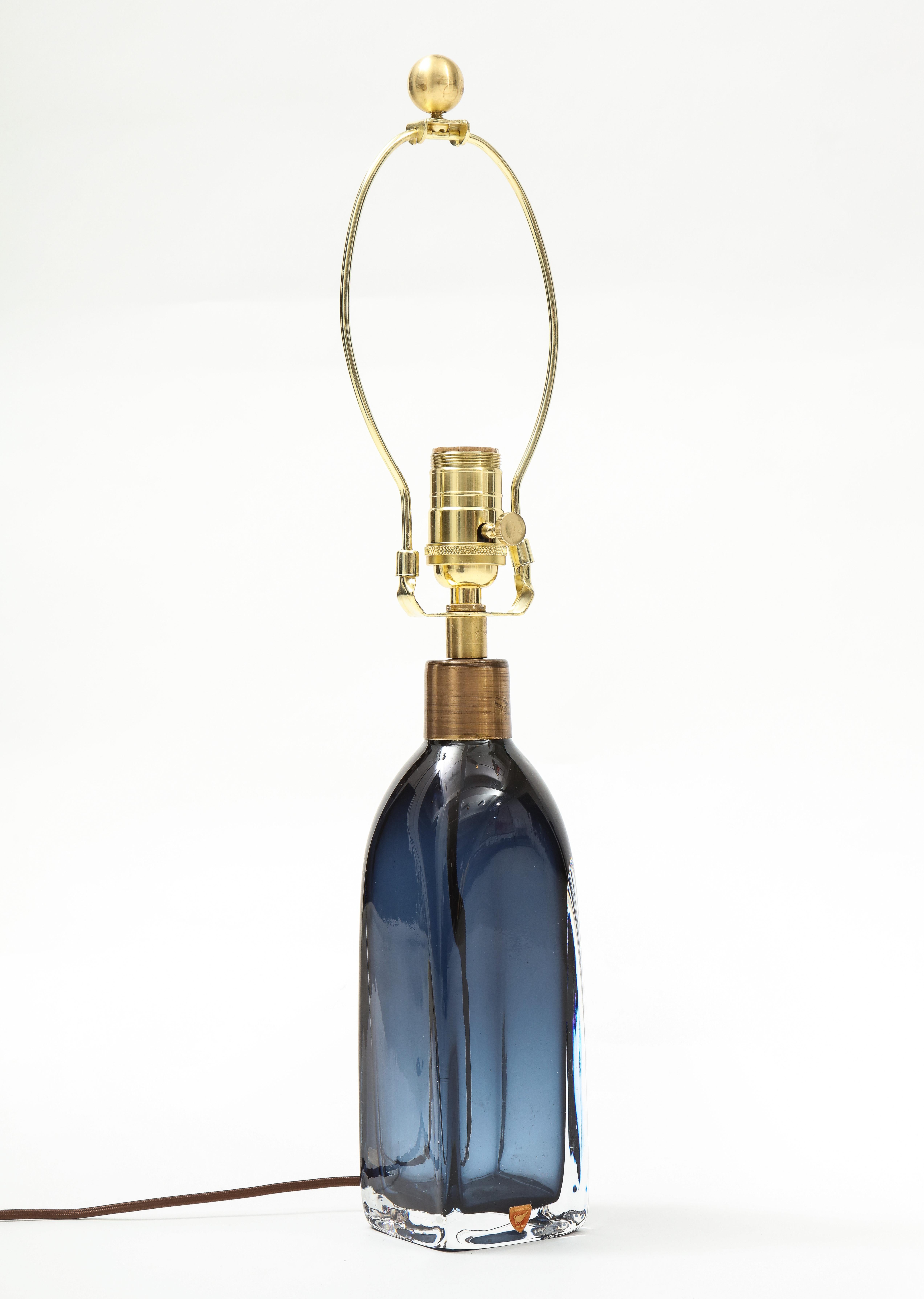 Rectangular sapphire blue crystal lamp with brass fittings
that has been newly rewired fir the US and takes a standard size light
bulb with a 75 watt maximum.